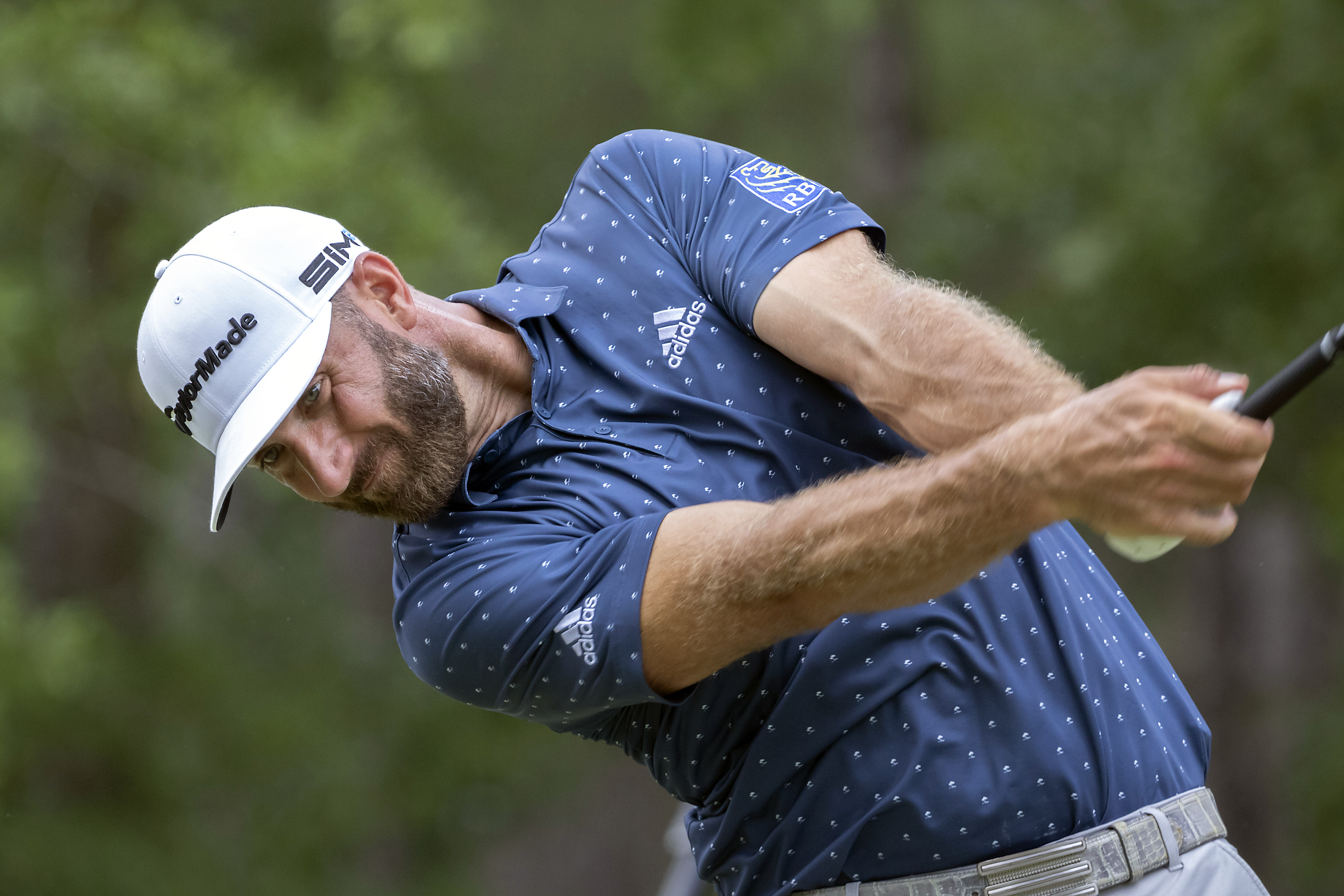Dustin Johnson hits his drive down the ninth fairway during the first round of Thursday's action.