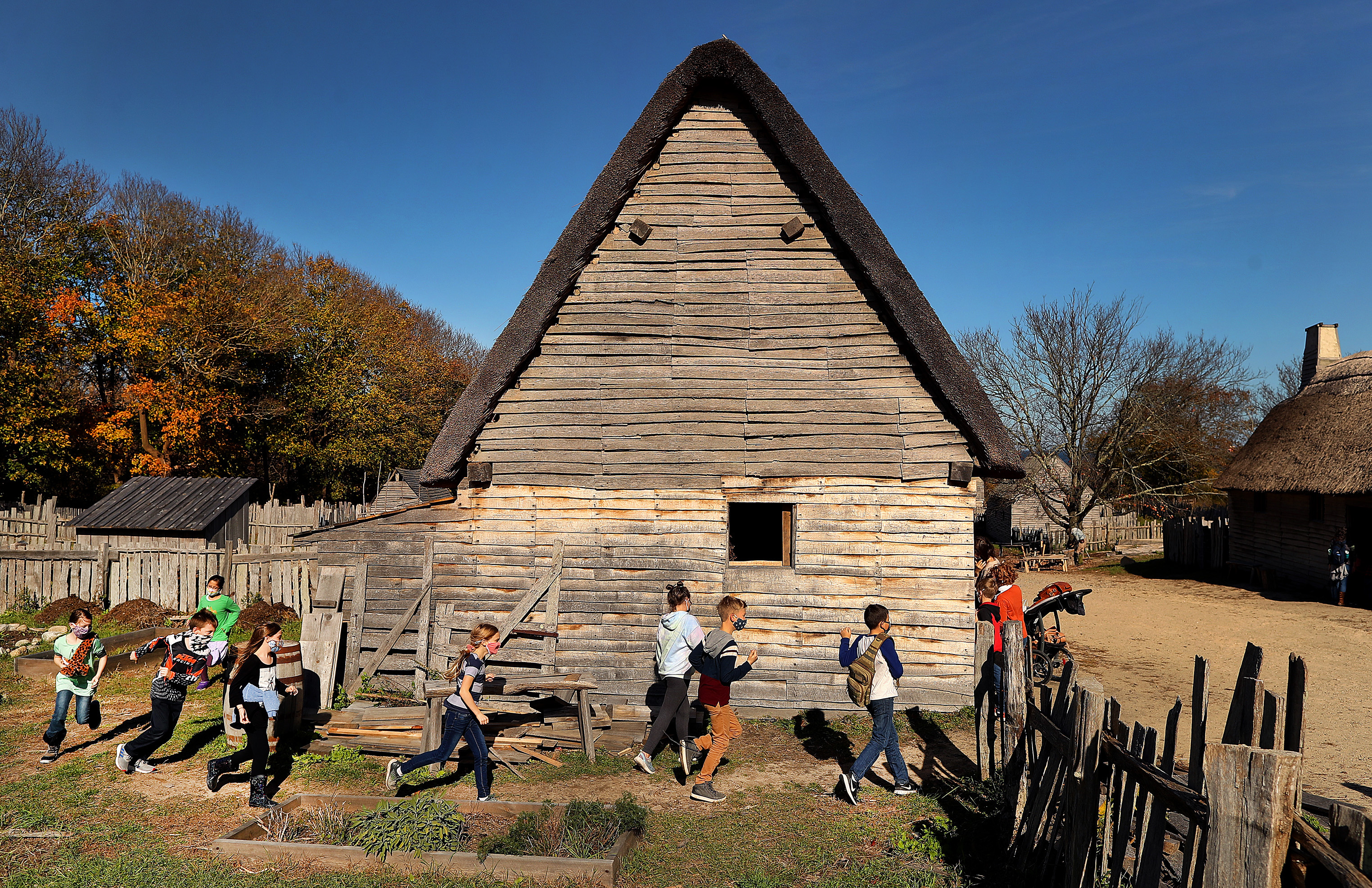 Youngsters run around a home in Pilgrim Village.