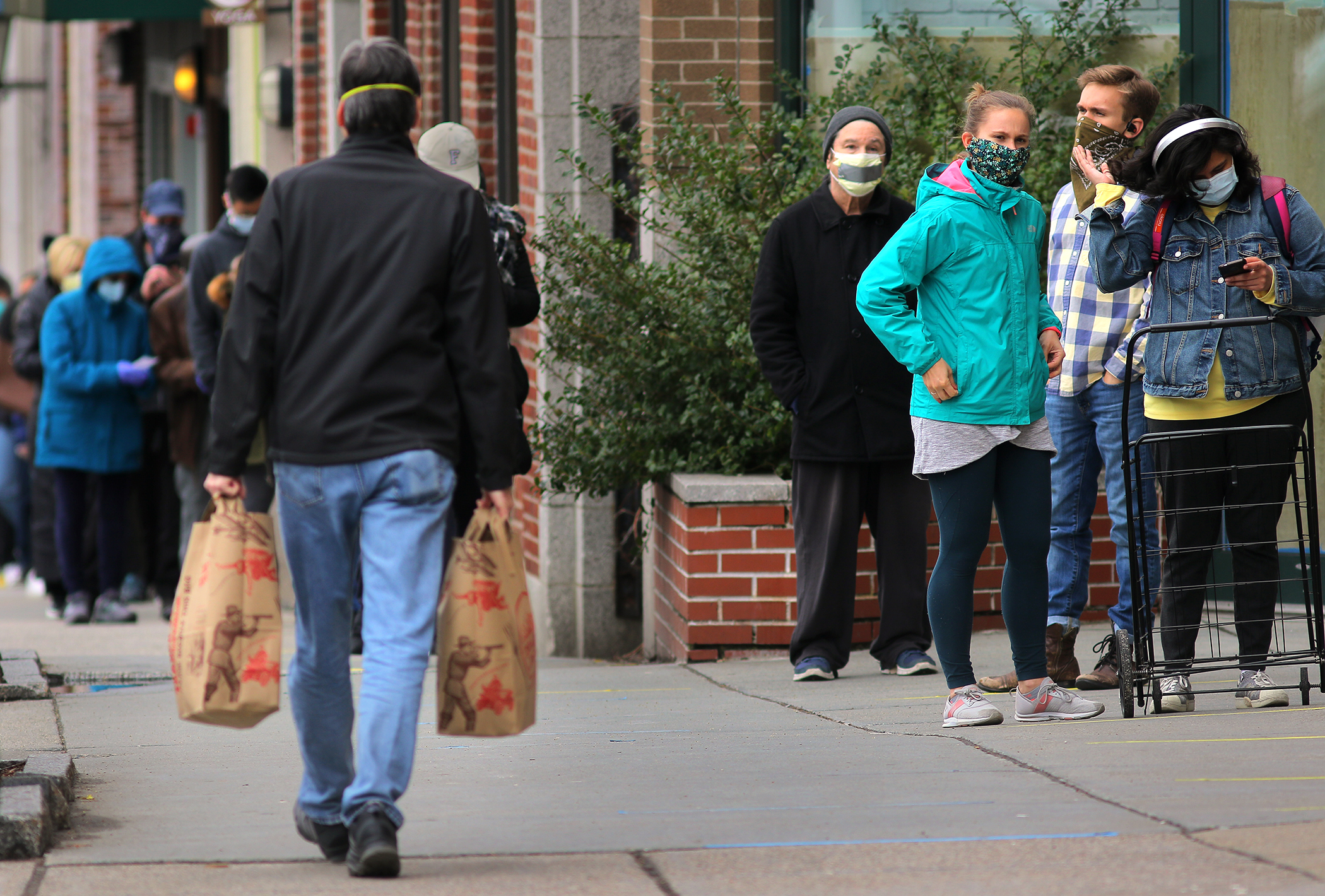 Customers came to and from Trader Joe's in Coolidge Corner.