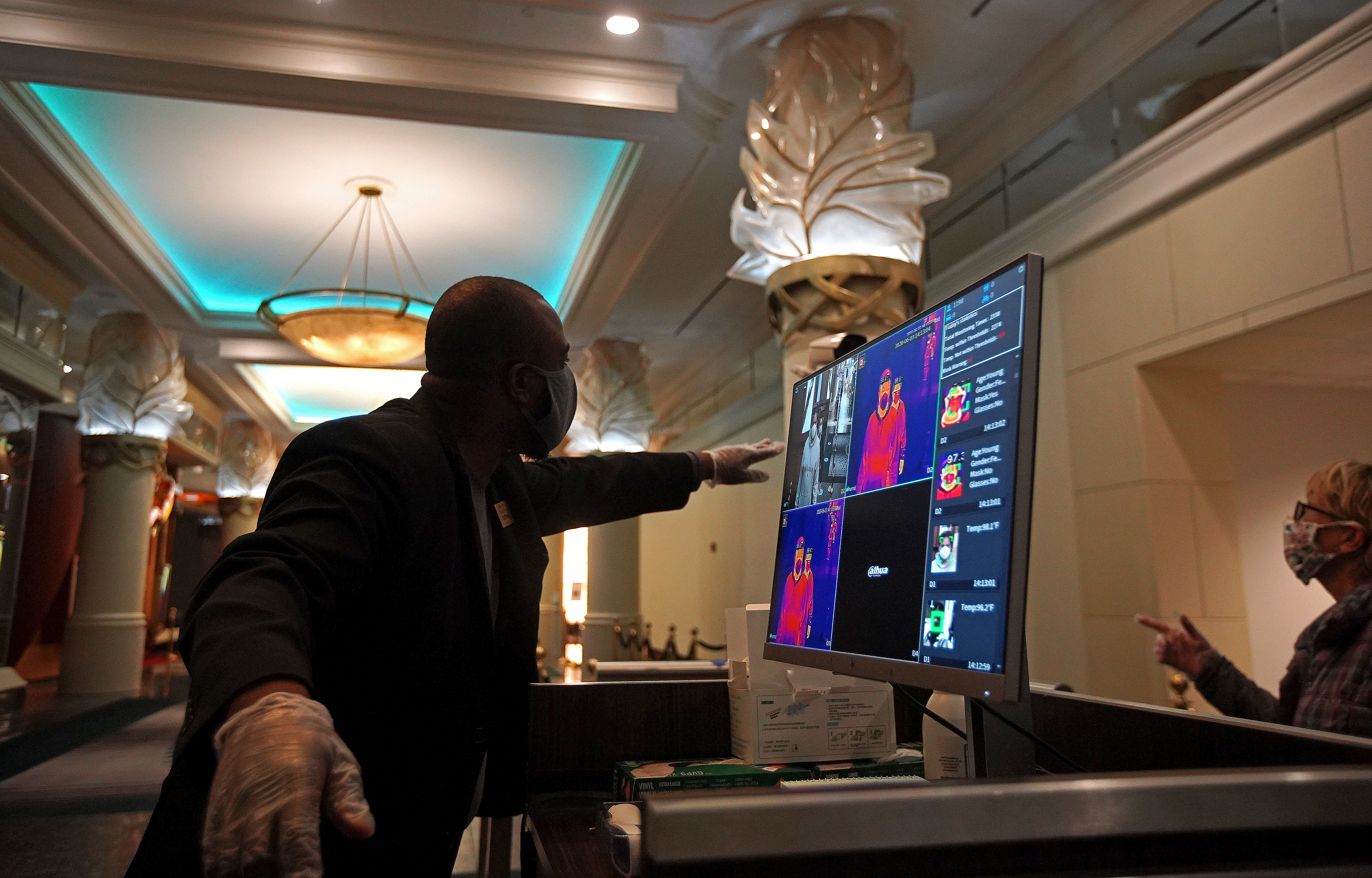 Darien Keen, a security supervisor, monitored a thermal imaging temperature screening station.