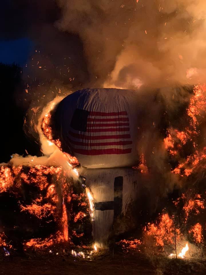 Few of the 19 bales of hay were salvageable. One bale of hay, adorned with an American flag logo, was saved for use in a smaller sign.