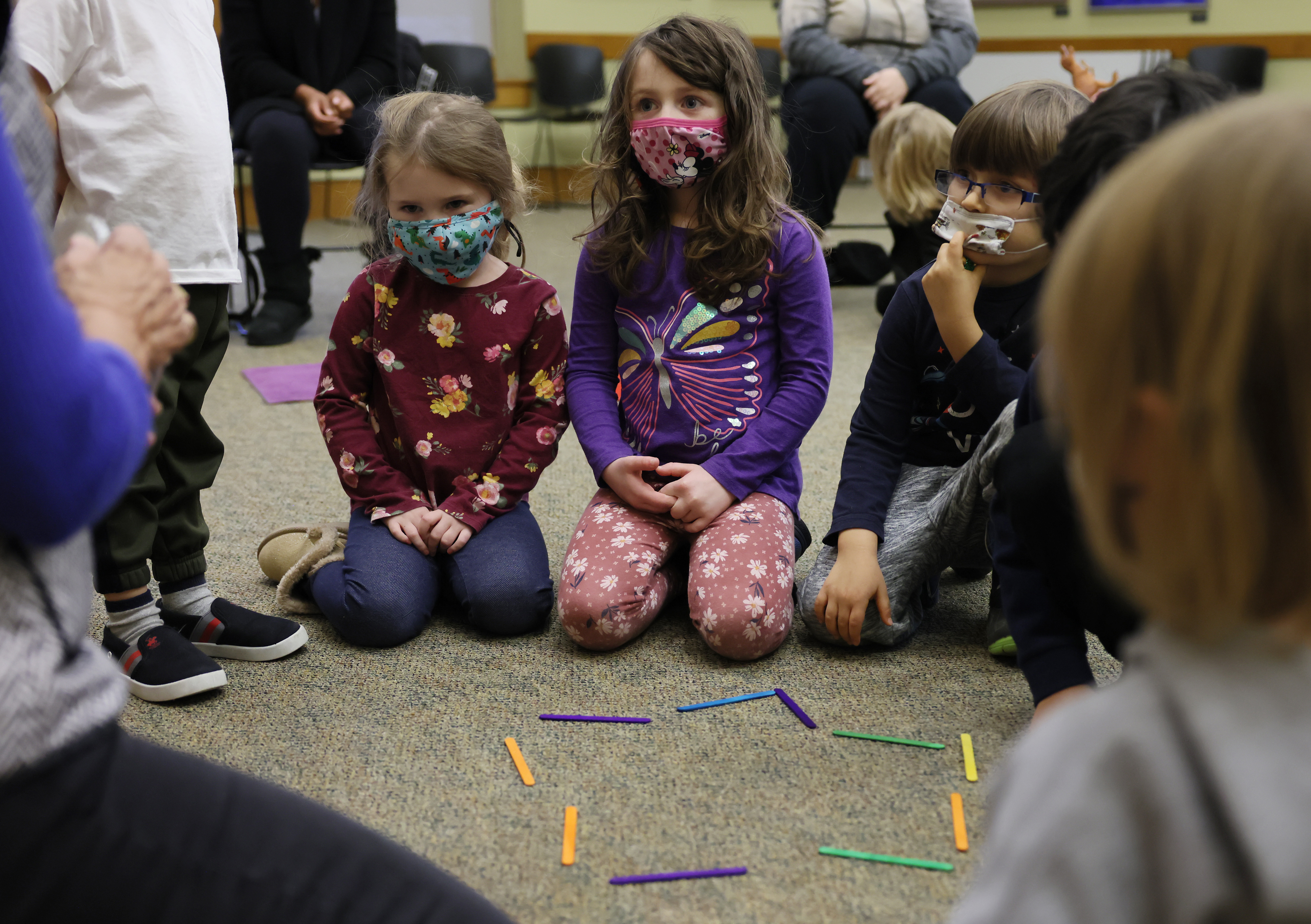 Left to right, Charlotte Wasgatt, 3, Keegan Morin, 4, and Alek Kaplan, 4, listened during a Young Scientist STEM program event on December 8 at the Northborough Free Library.