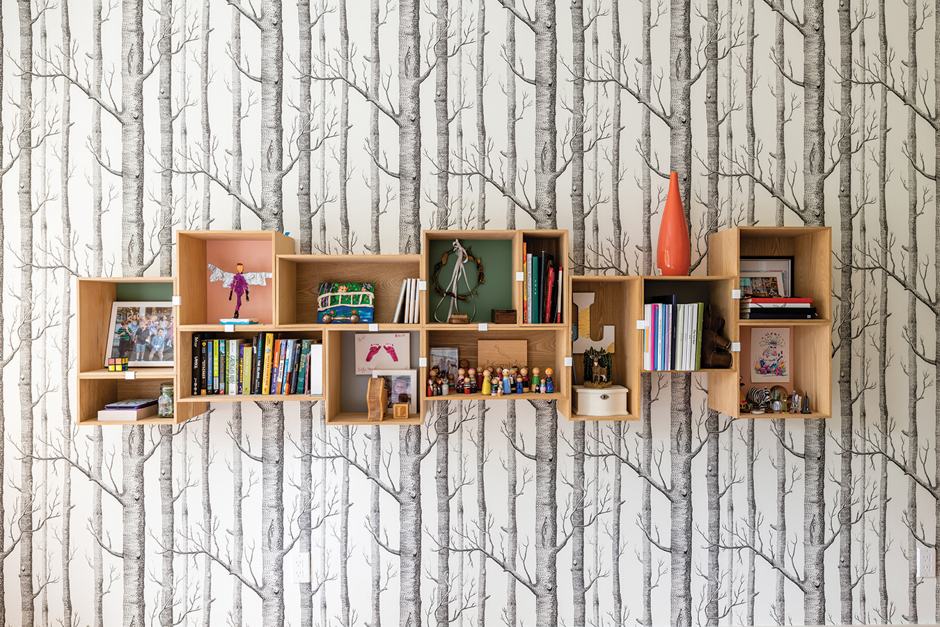 An arrangement of wooden boxes by Muuto helps keep collections off the floor.