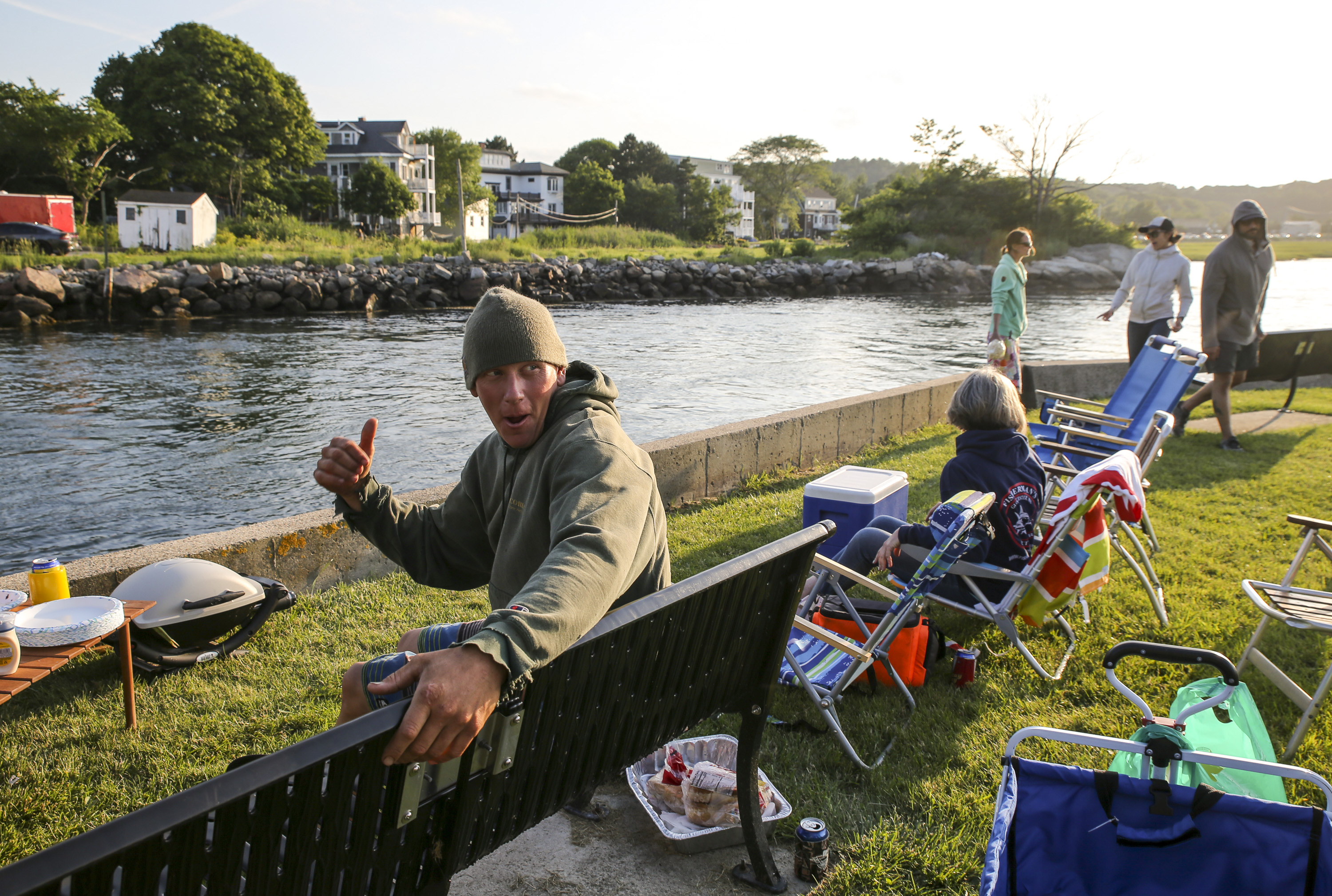 John Stevens, known for his Instagram account @cutbridgecrazziness where he films boating incidents under the Cut Bridge, is joined by friends in his backyard to watch boats along the water.