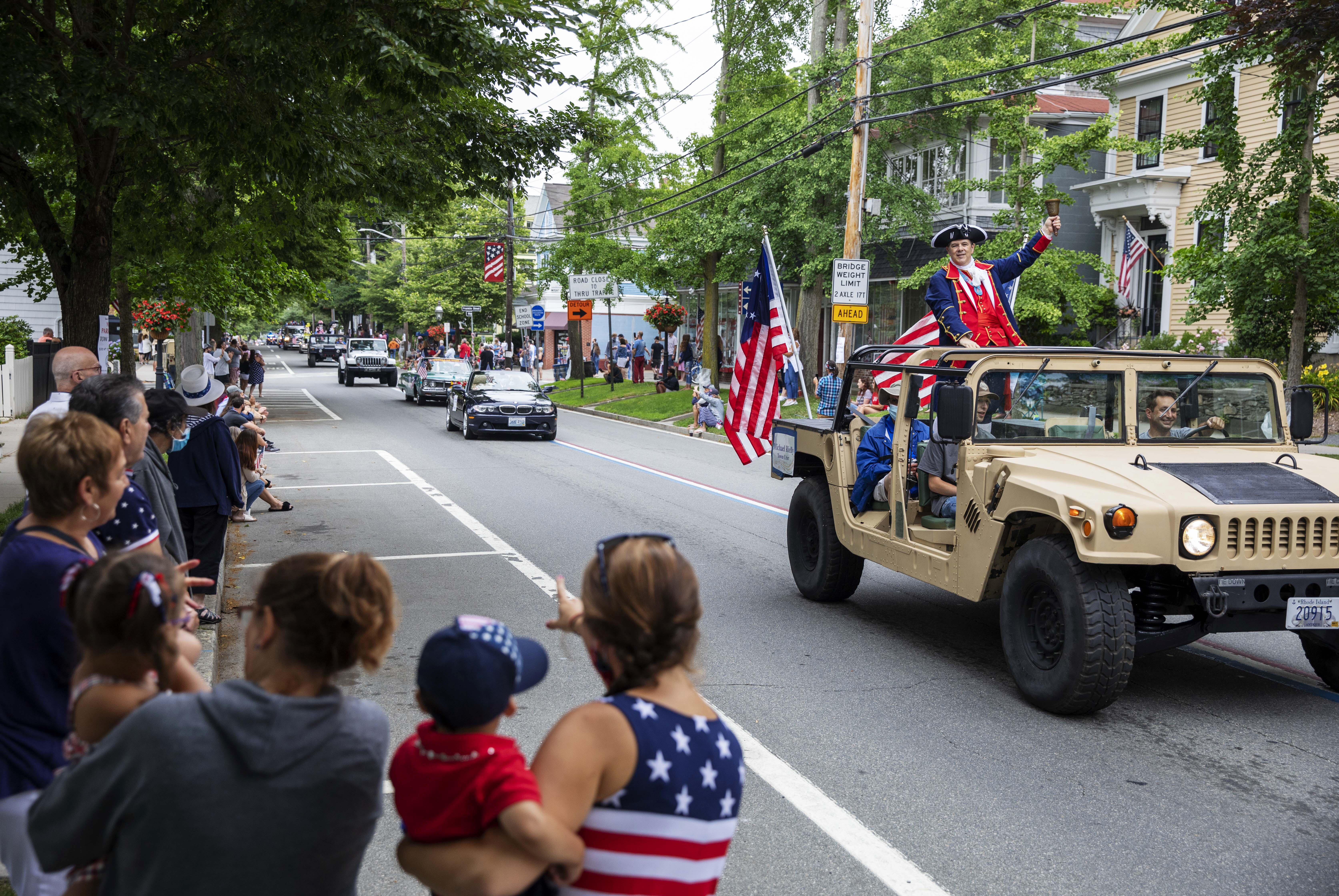 Spectators watched as a Fourth of July parade passed on July 4, 2020, in Bristol, R.I. The town, which lays claim to the nation's oldest Independence Day celebration in the country, held a vehicle-only, scaled-down version of its annual parade in 2020 due to the coronavirus pandemic.