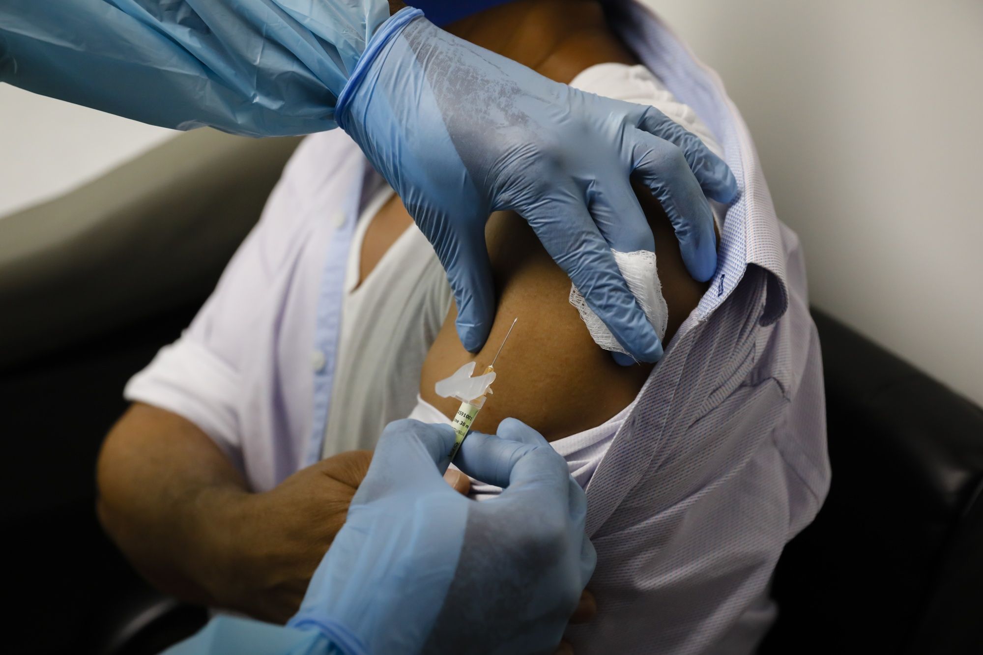 A health worker injected a person Sept. 9 during a clinical trial for a Pfizer
COVID-19 vaccine at Research Centers of America in Hollywood, Fla.