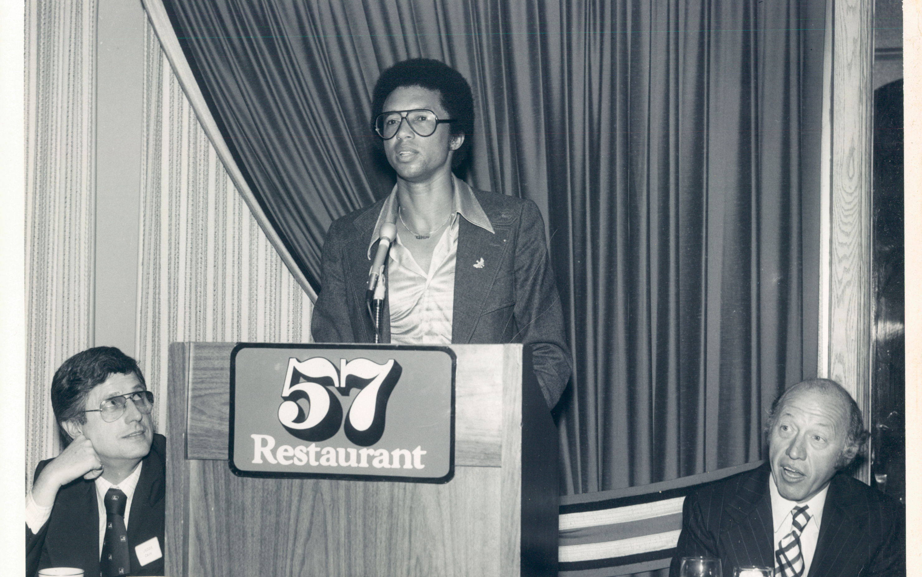 The Globe's Bud Collins (right), who was an early champion of Sportsmen's, is shown in 1977 with tennis great Arthur Ashe (center).