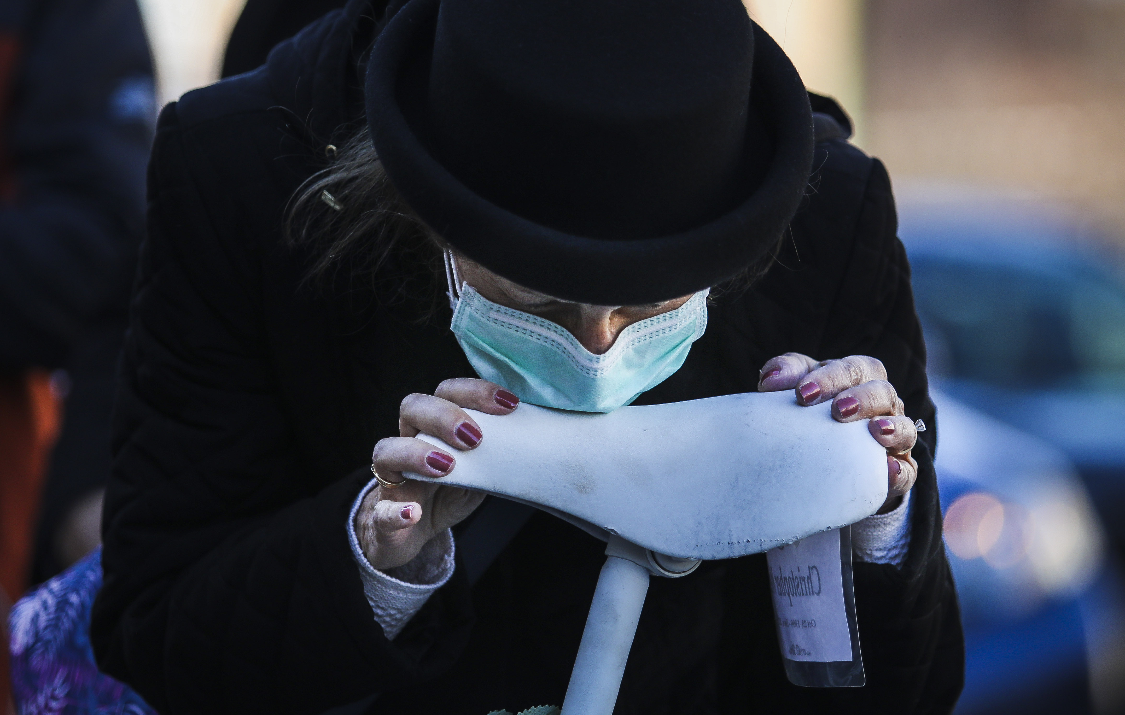 Bonnie Weigl kissed the seat of a ghost bike commemorating her late son, Christopher.
