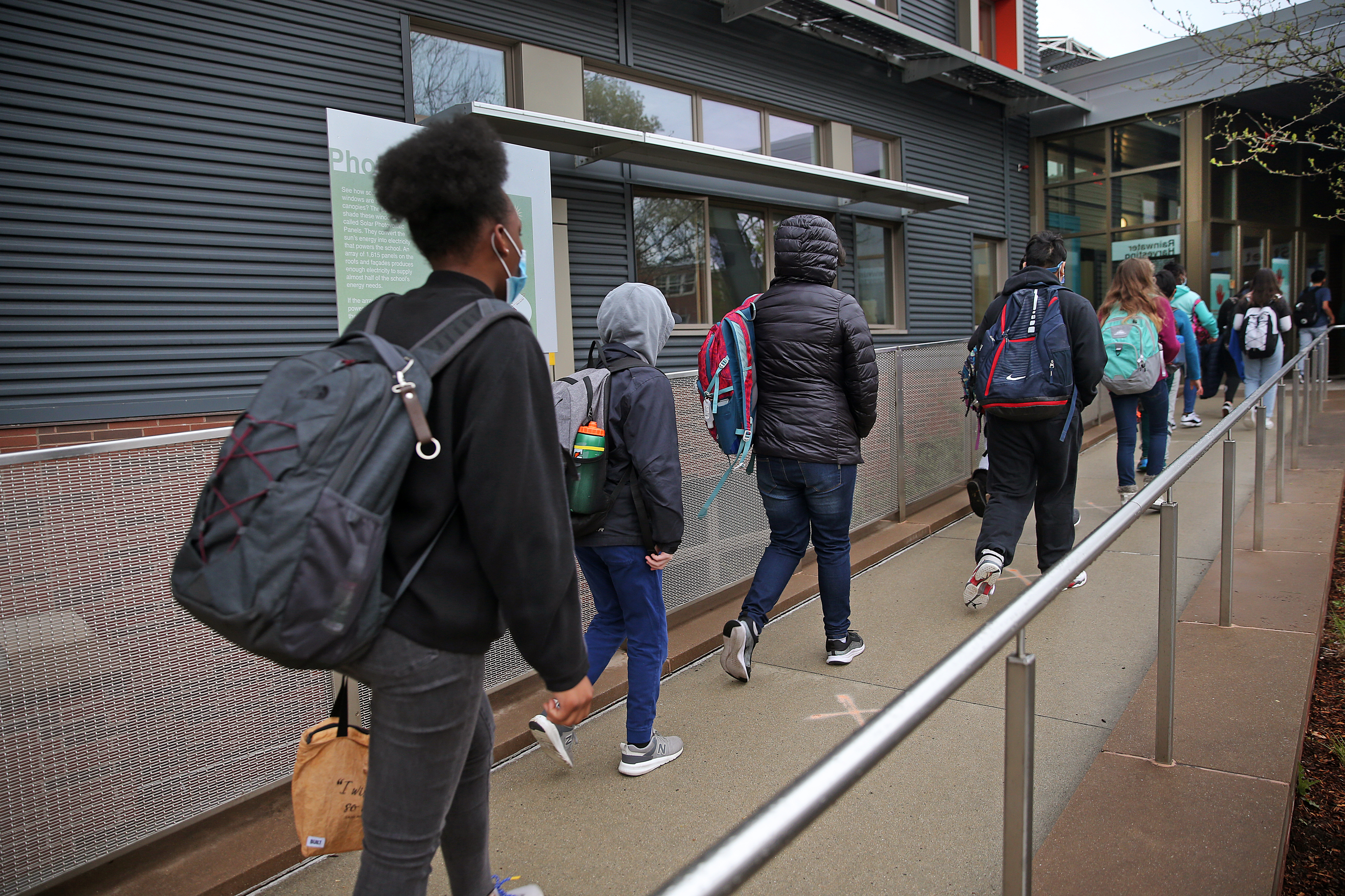 Students arrive at the Putnam Avenue Upper School ,Cambridge. Middle schools will reopen for full-time in-person learning on Wednesday in Cambridge along with many other middle schools across Massachusetts.
