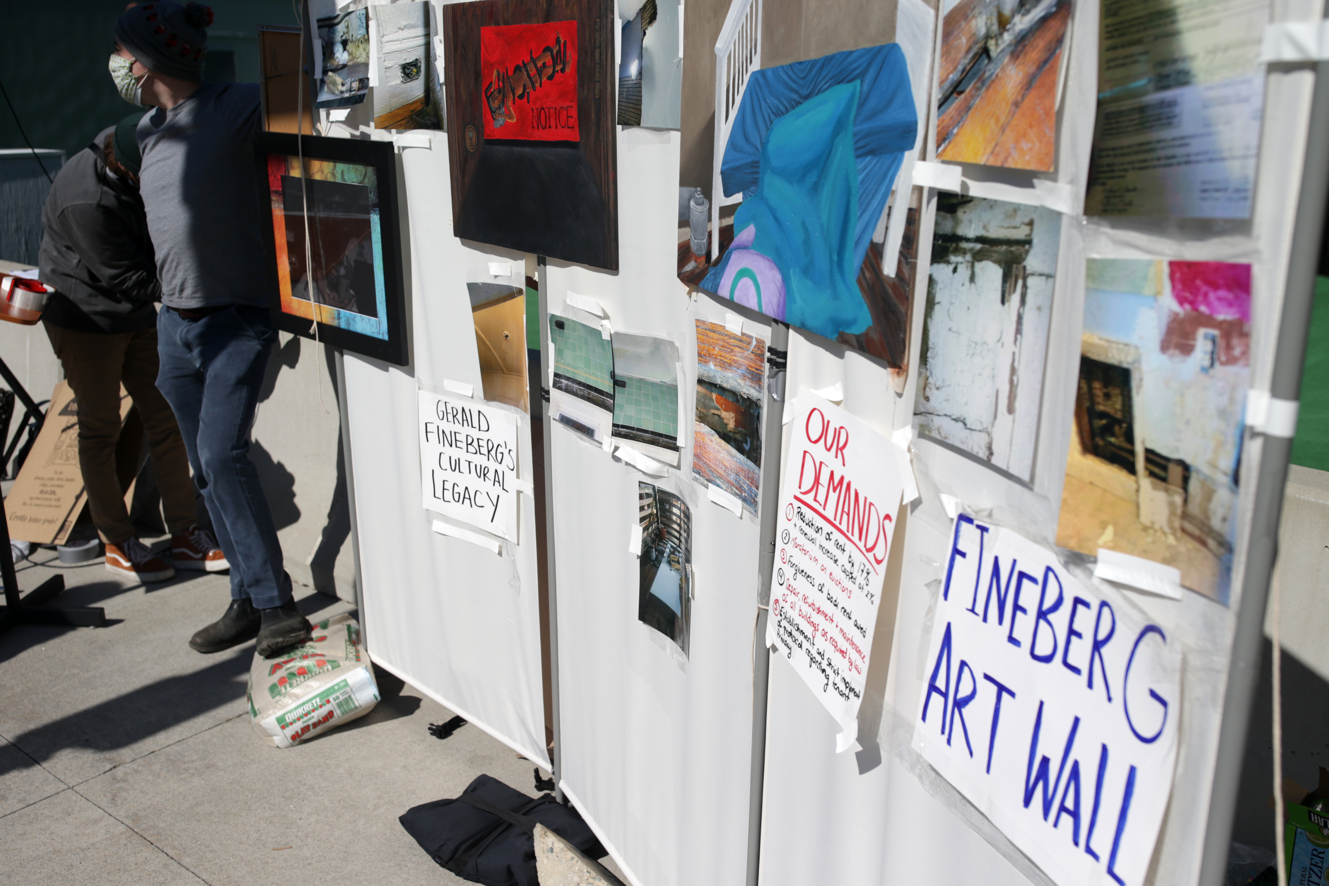 A pop-up art wall at a rally in South Boston to protest against Fineberg Management, Inc., alleged practices toward its tenants. Some of the art was produced by tenants.