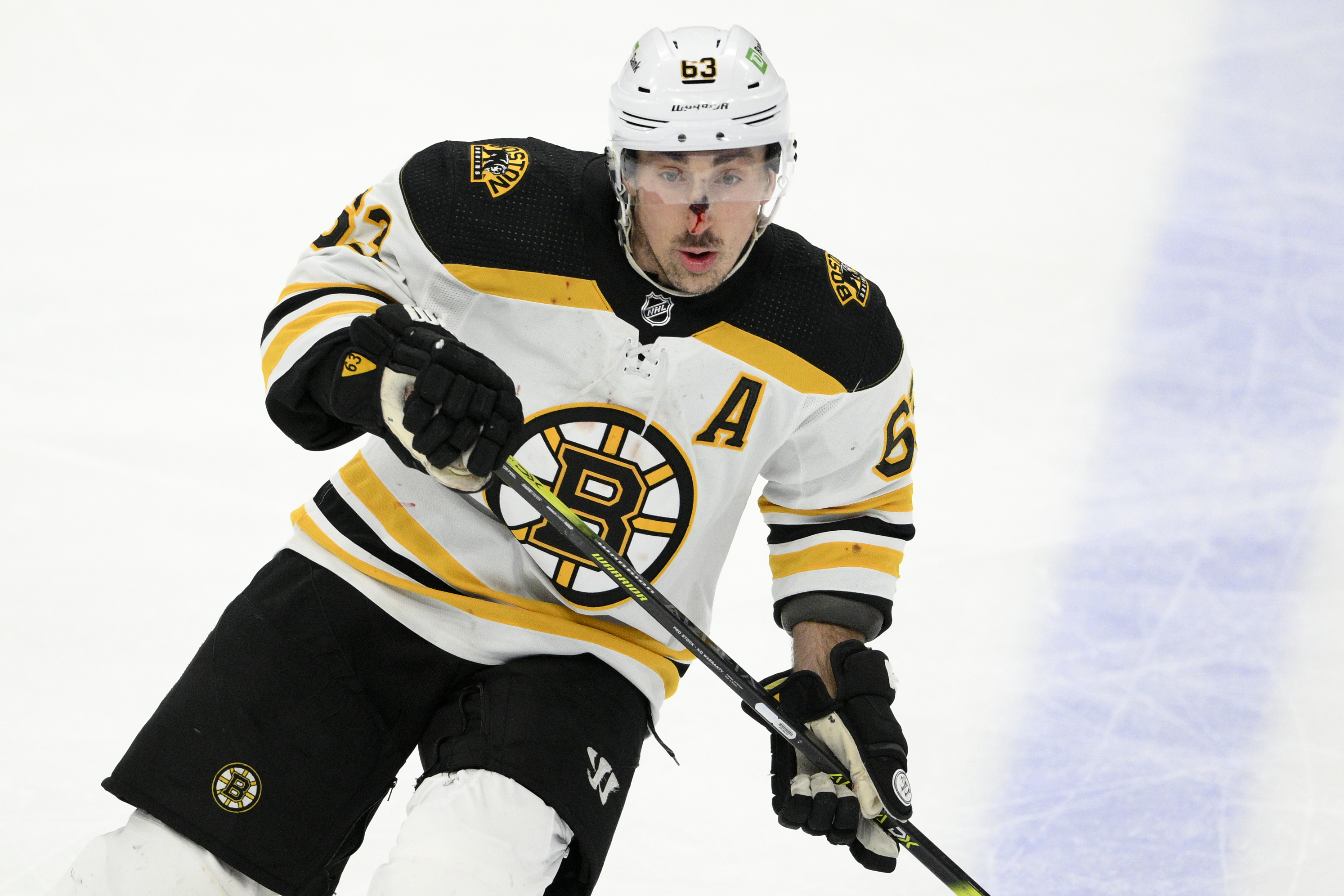 NHL referee takes out Bruins' Brad Marchand with surprise check in