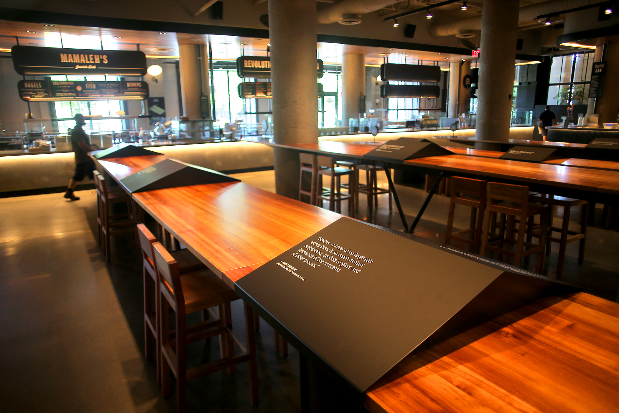 Dining spaces at Time Out Market have been separated by barriers carrying quotes from famous Bostonians.