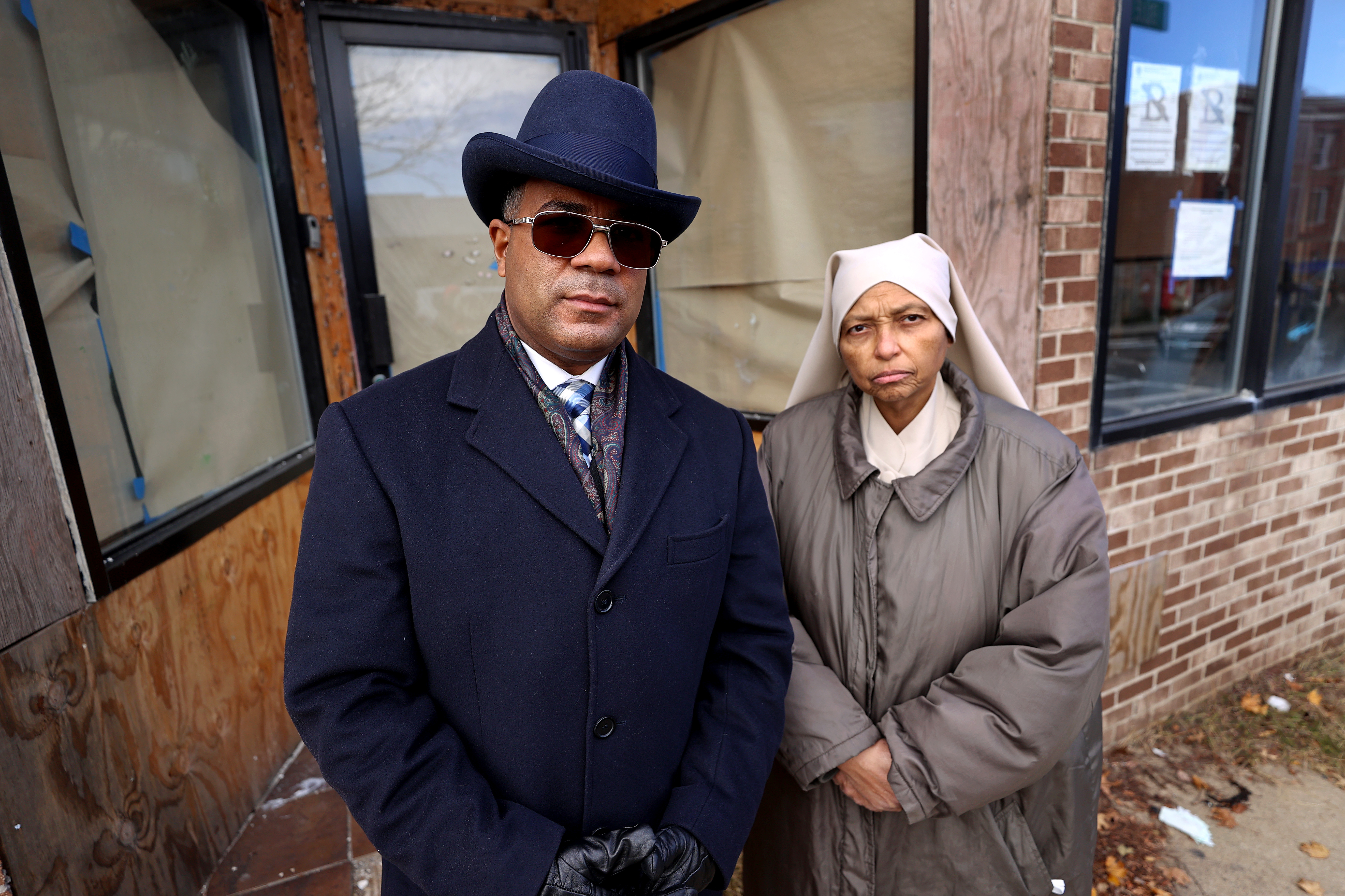 Minister Randy Muhammad and Yvette Muhammad, the daughter of Minister Don Muhammad, stood by the entrance of the EnRoot business on Blue Hill Avenue.