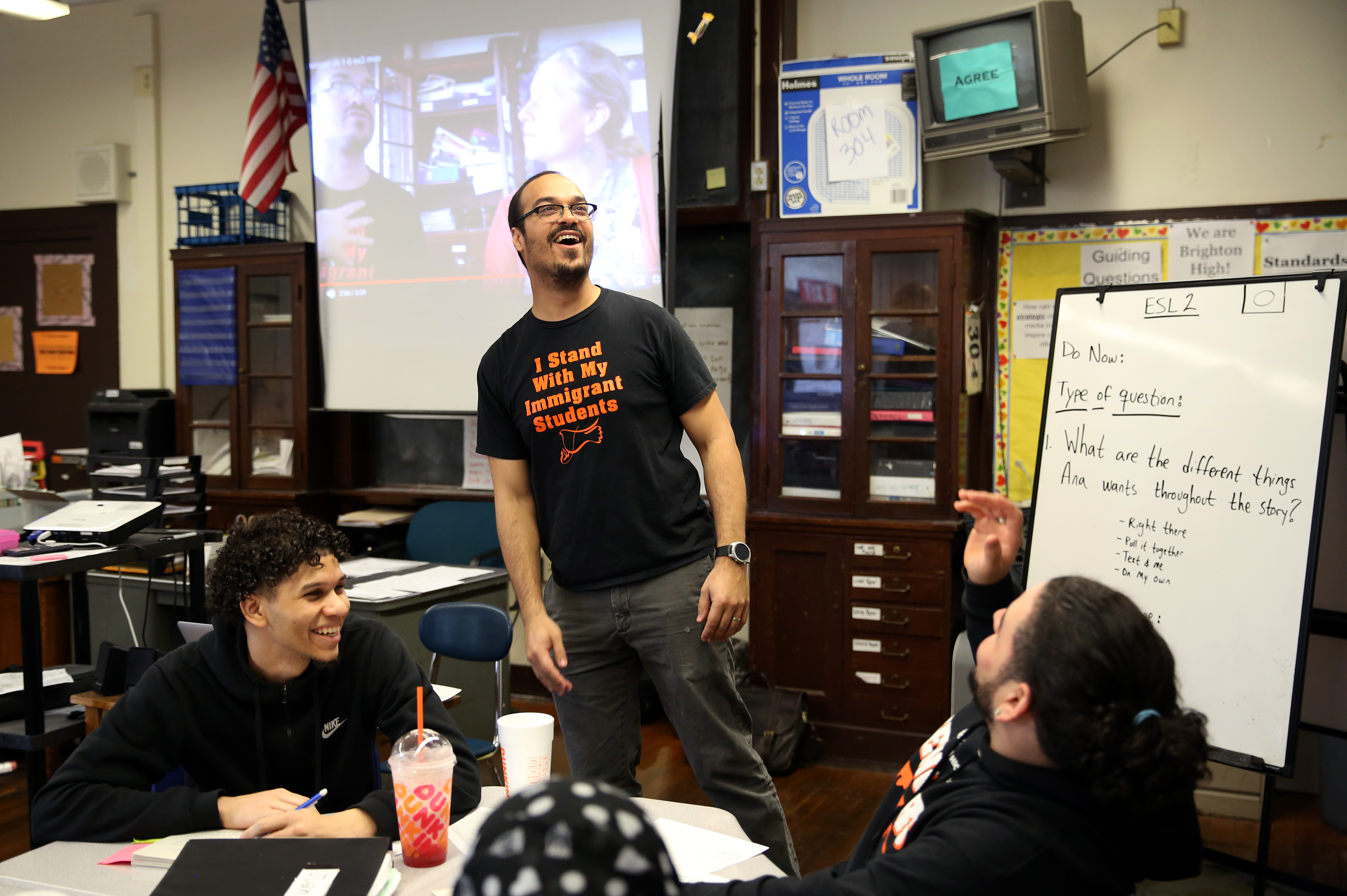ESL teacher Ramon Trinidad (center) tossed a Jolly Rancher to one of his students who gave a correct answer as Juan Terrero (left) looked on at Brighton High School.