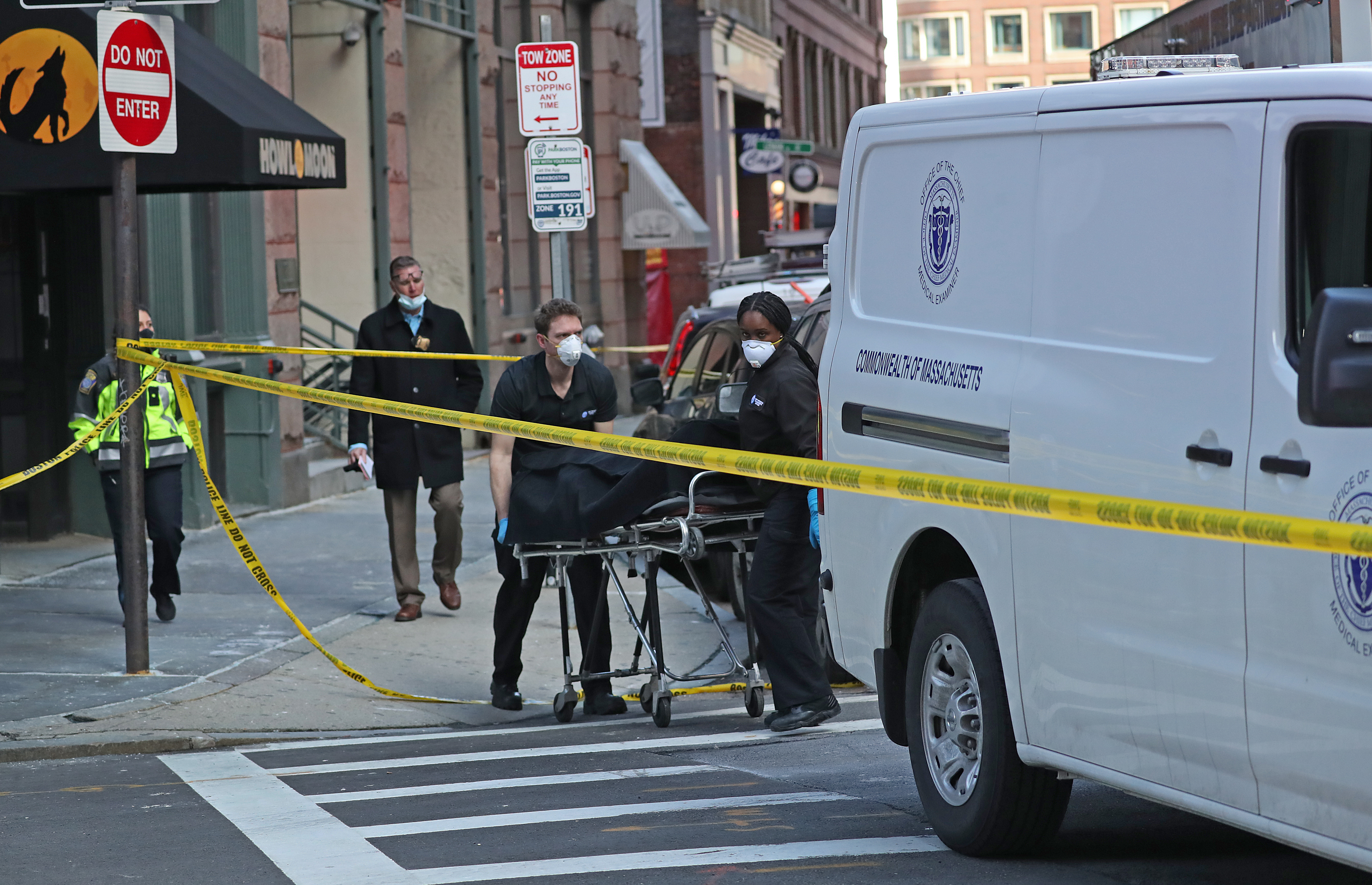 One of the victims was placed in the coroner transit van.