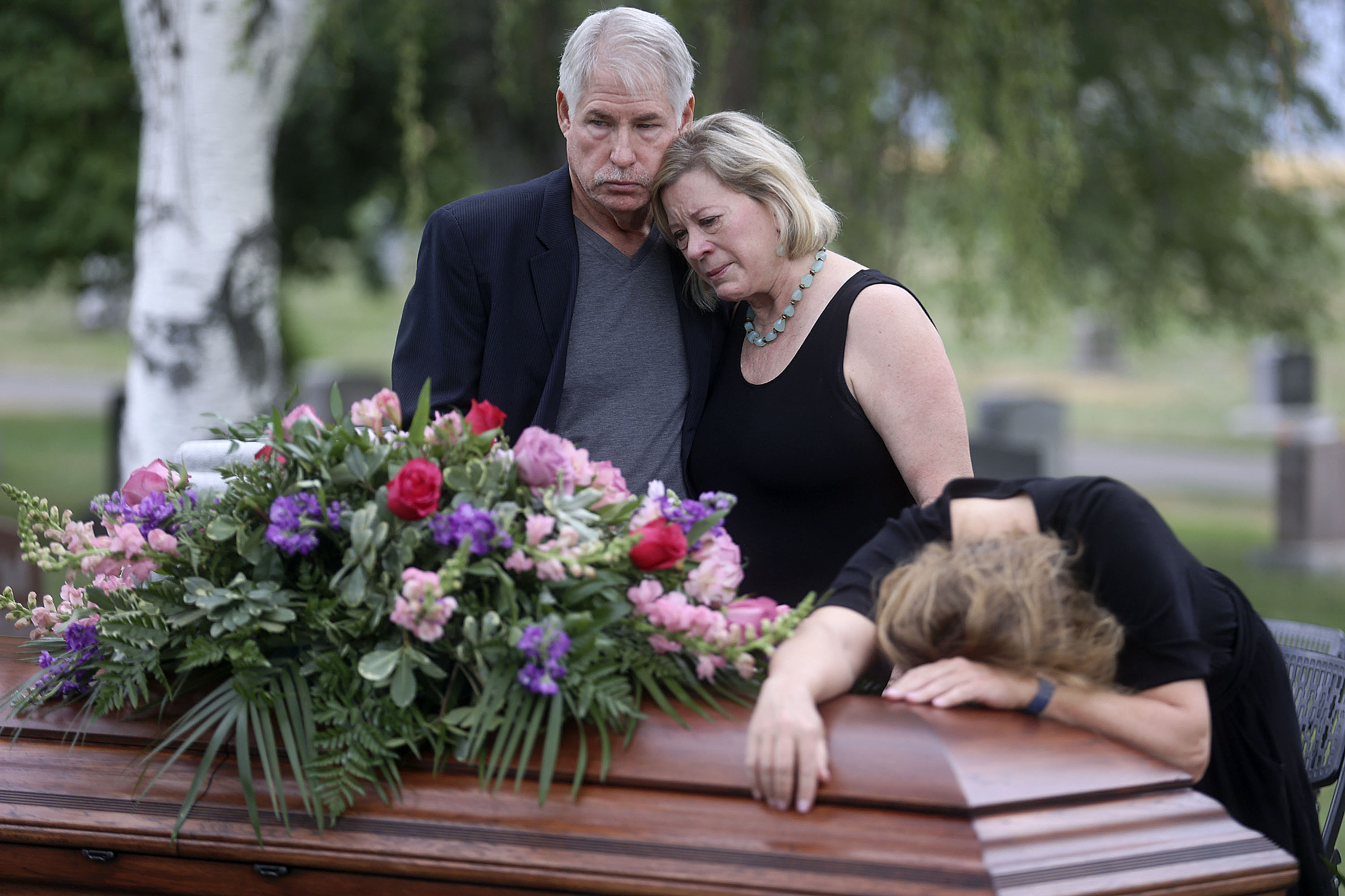 Clark Knighton and Shari Knighton hugged as Tricia Wright wept over the casket of Shari and Tricia's sister, Shawna Wright, who died of heat exhaustion while homeless in Salt Lake City on July 13.