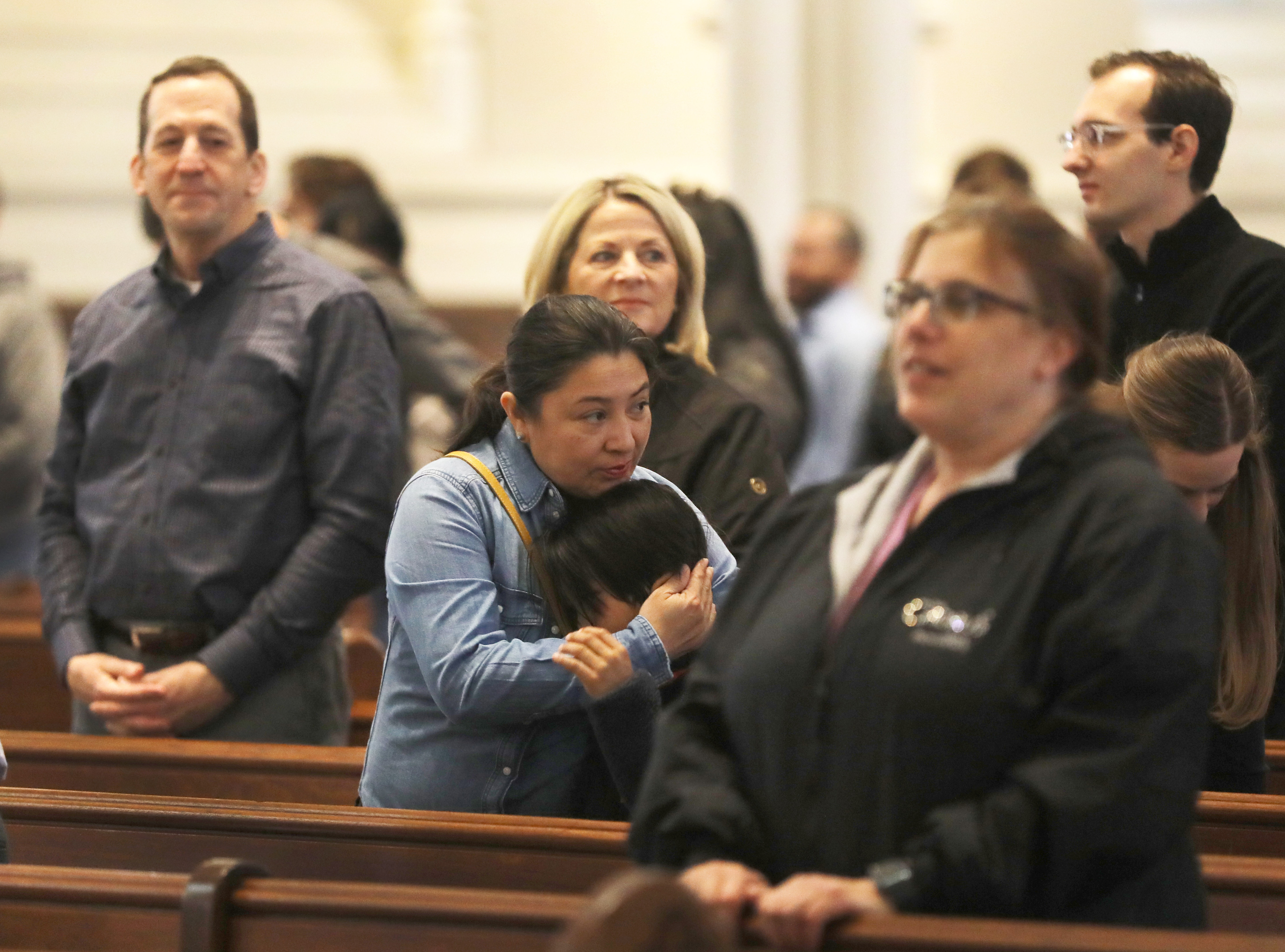 Claudia Ortiz hugged her 9-year-old son Mateo during the giving of the sign of peace during Mass at the Cathedral of the Holy Cross on March 8.