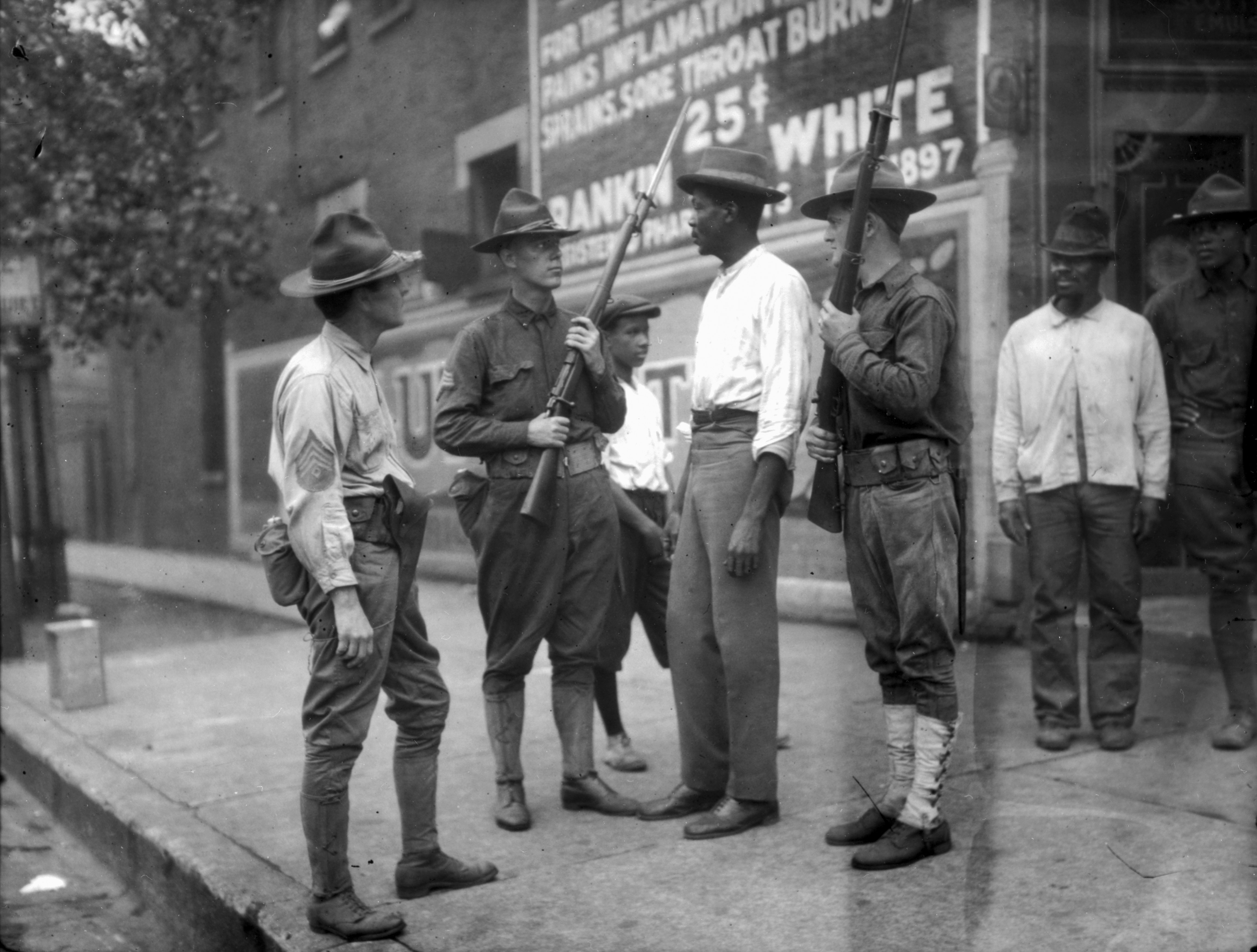 National Guardsmen questioned a Black man in Chicago in 1919.