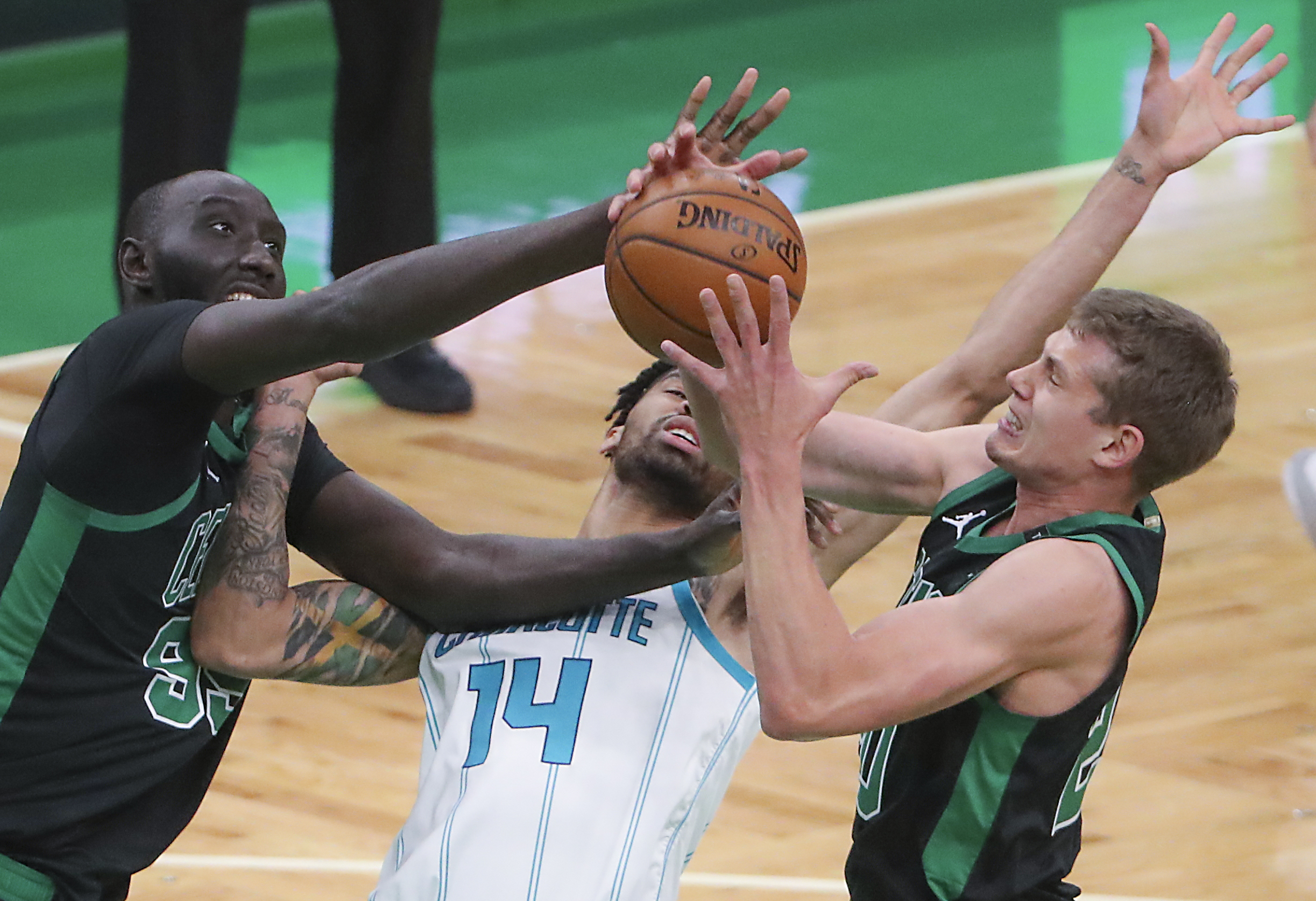 Tacko Fall and Moe Wagner battle Charlotte's Nick Richards for a fourth-quarter rebound Sunday night.