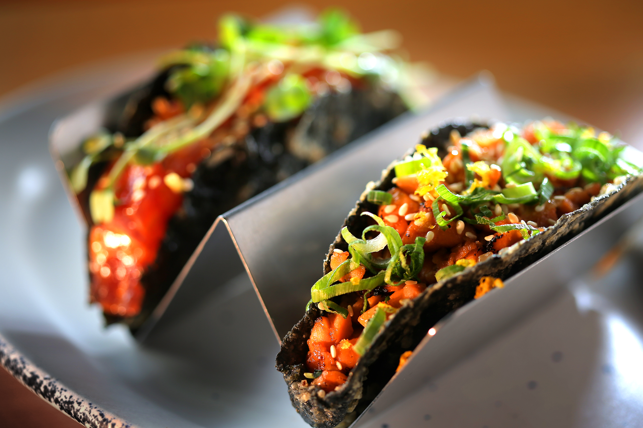 Torched salmon teriyaki and spicy tuna crispy nori sushi tacos at Mr. Roni Cups.