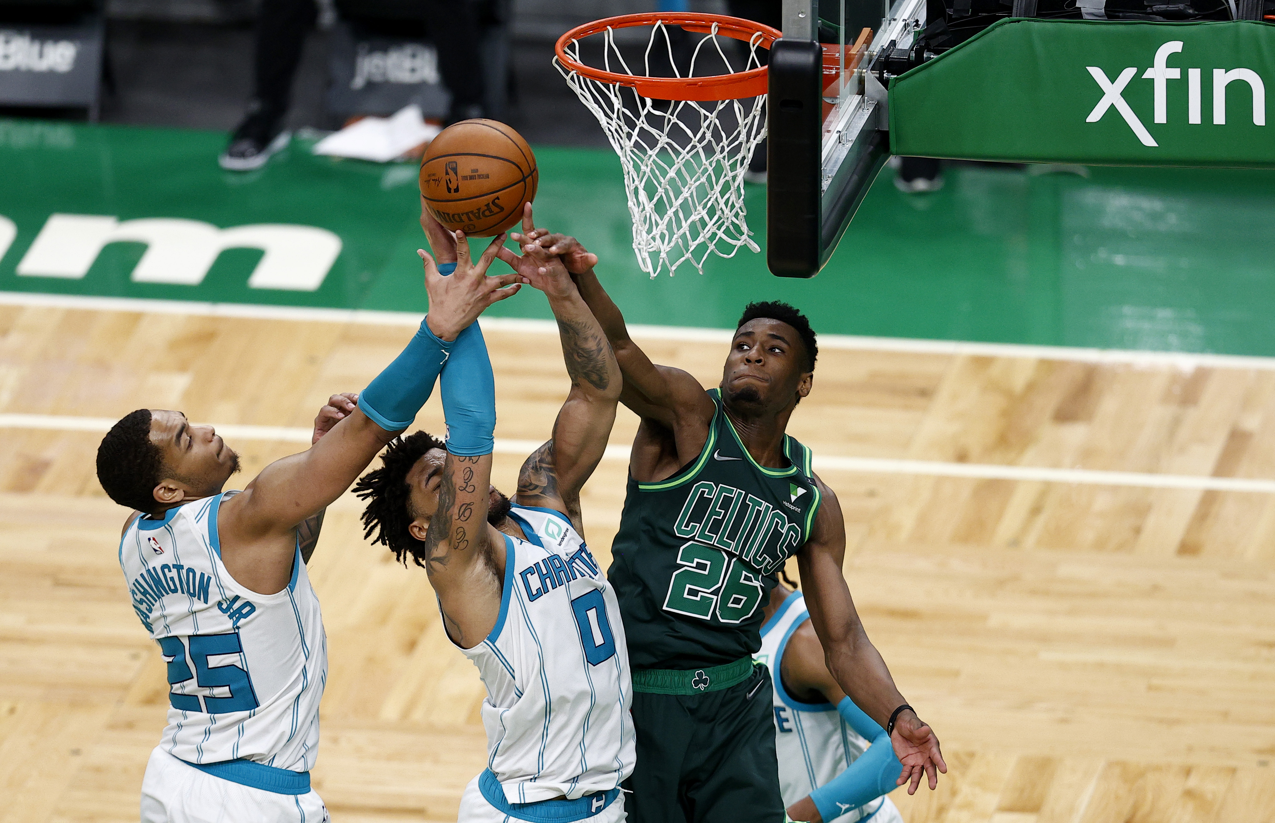 Aaron Nesmith (right) battles for a rebound Wednesday against the Hornets. Nesmith had his best game as a pro, finishing with 15 points.