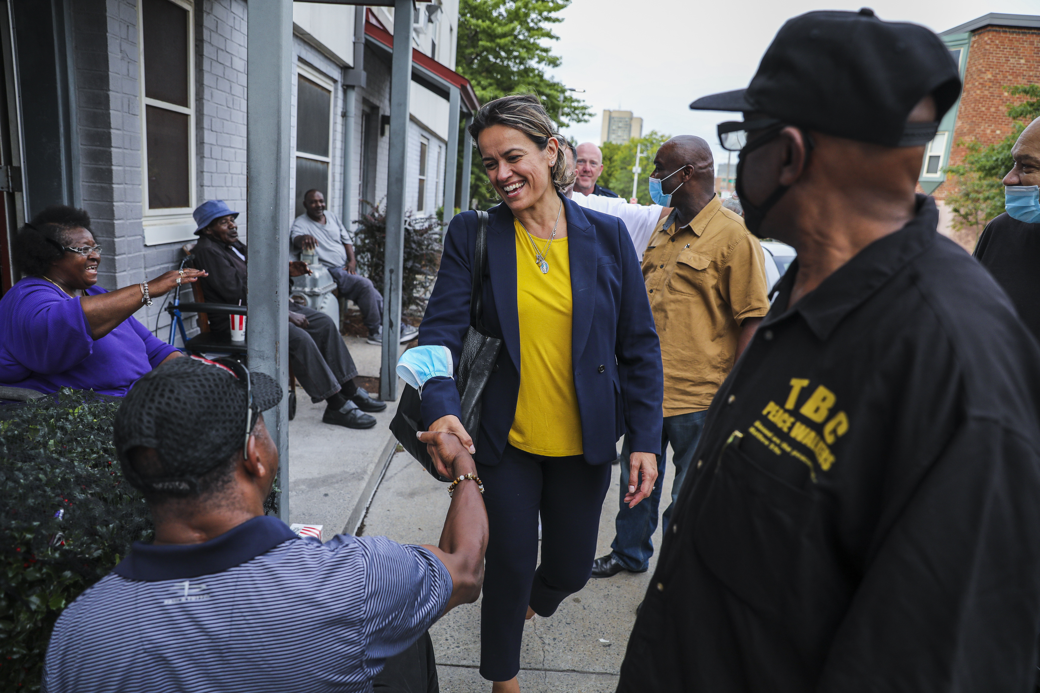 Annissa Essaibi George met Roxbury residents Friday while joining the Rev. Arthur T. Gerald Jr. (right) on the Twelfth Baptist Church's weekly peace walk.