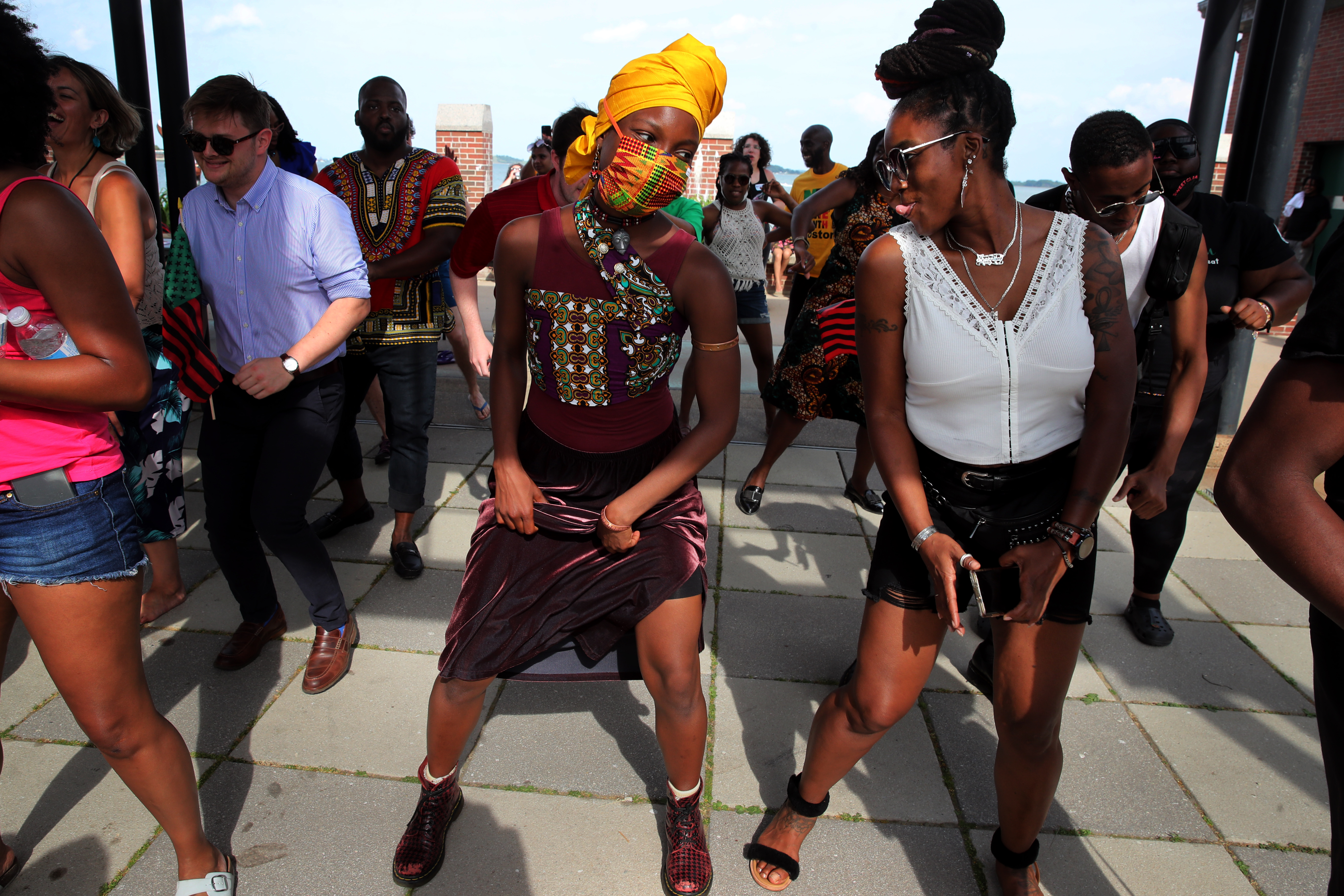 NaShaya Wornum and her mother Shernita dance the Electric Slide during the Juneteenth Boston: Black Joy celebration at Carson Beach, Saturday.