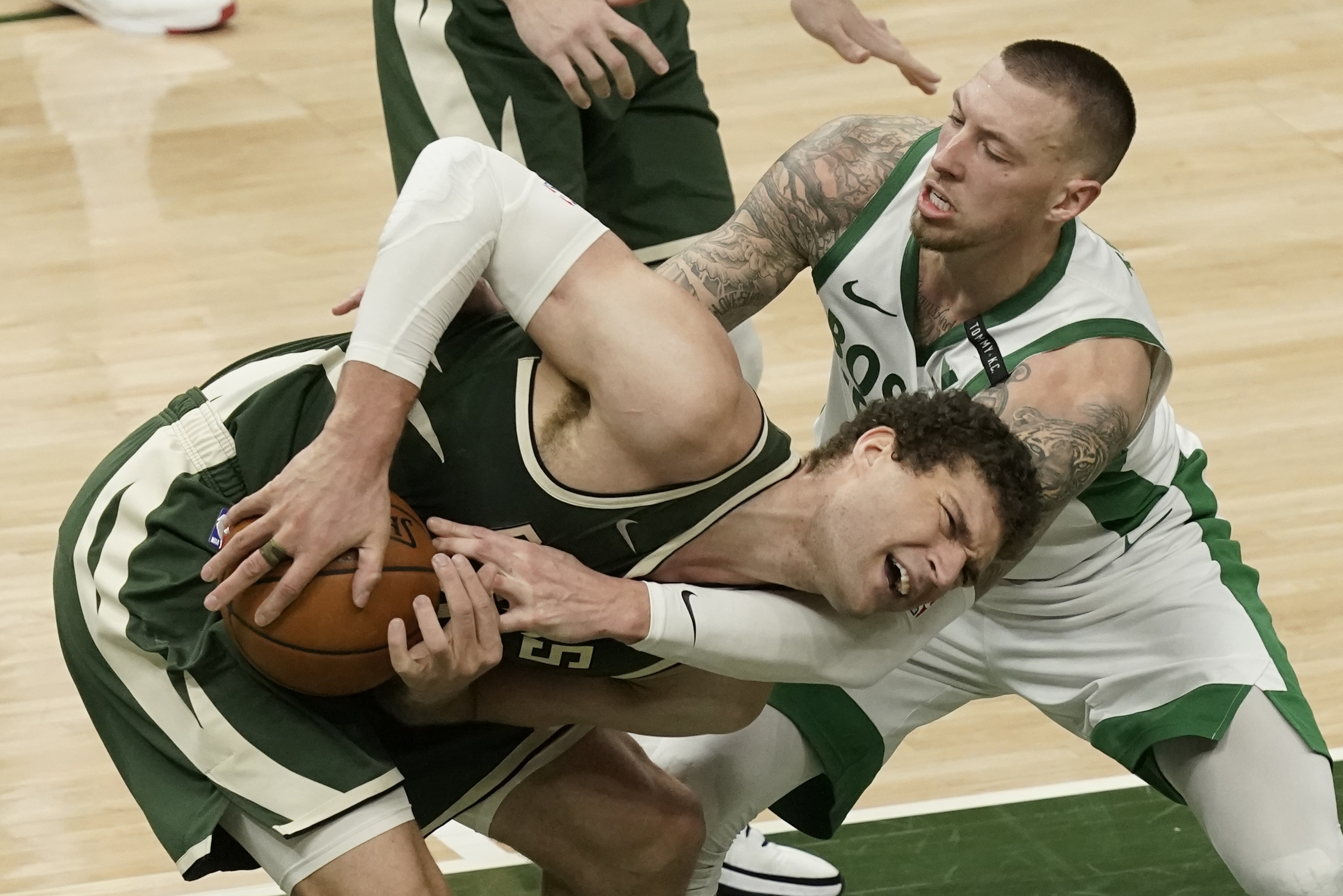Milwaukee's Brook Lopez and Daniel Theis battle for a rebound during the second half of Wednesday's game.
