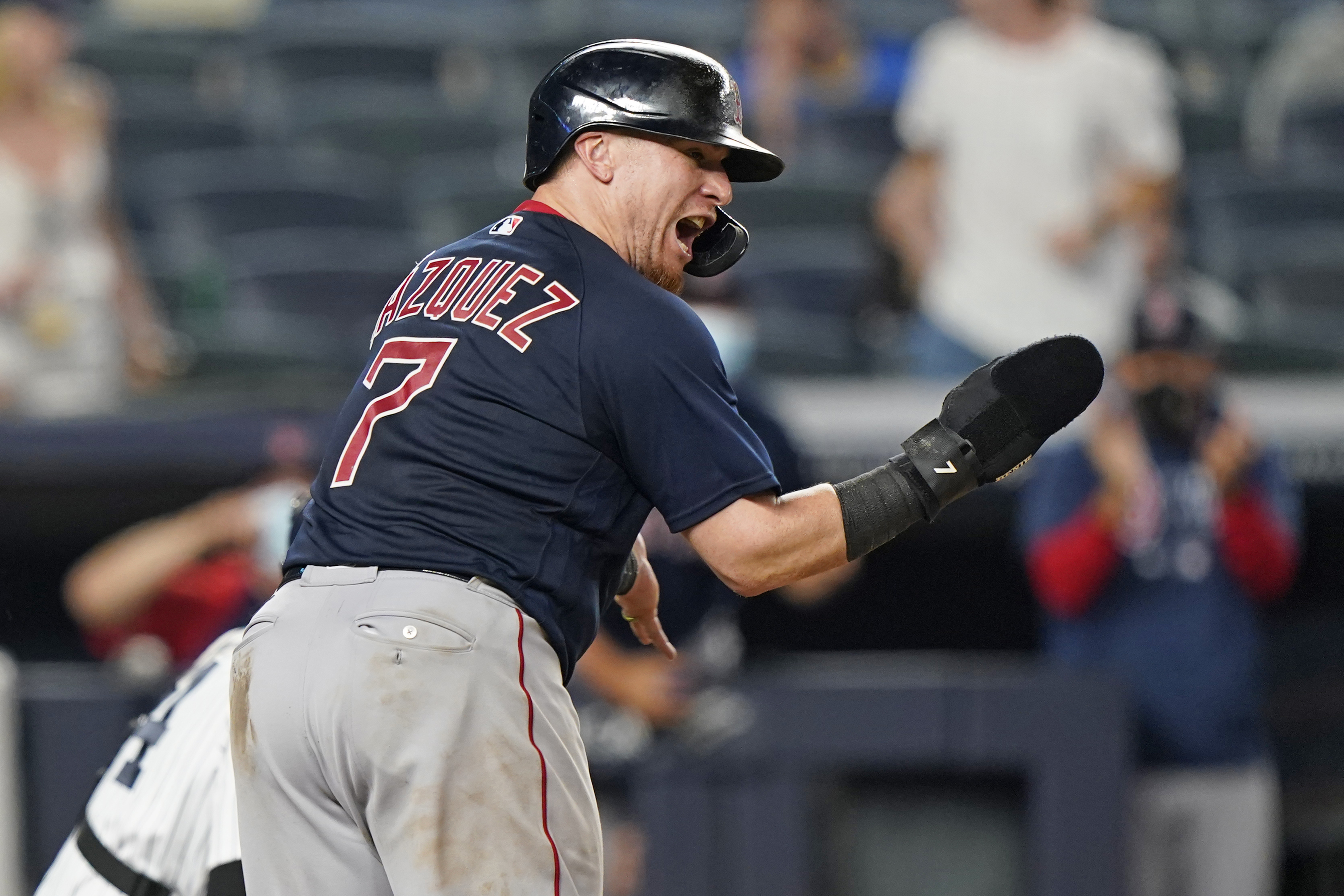Christian Vazquez reacts after scoring on Xander Bogaerts' two-run single in the 10th inning Sunday night.
