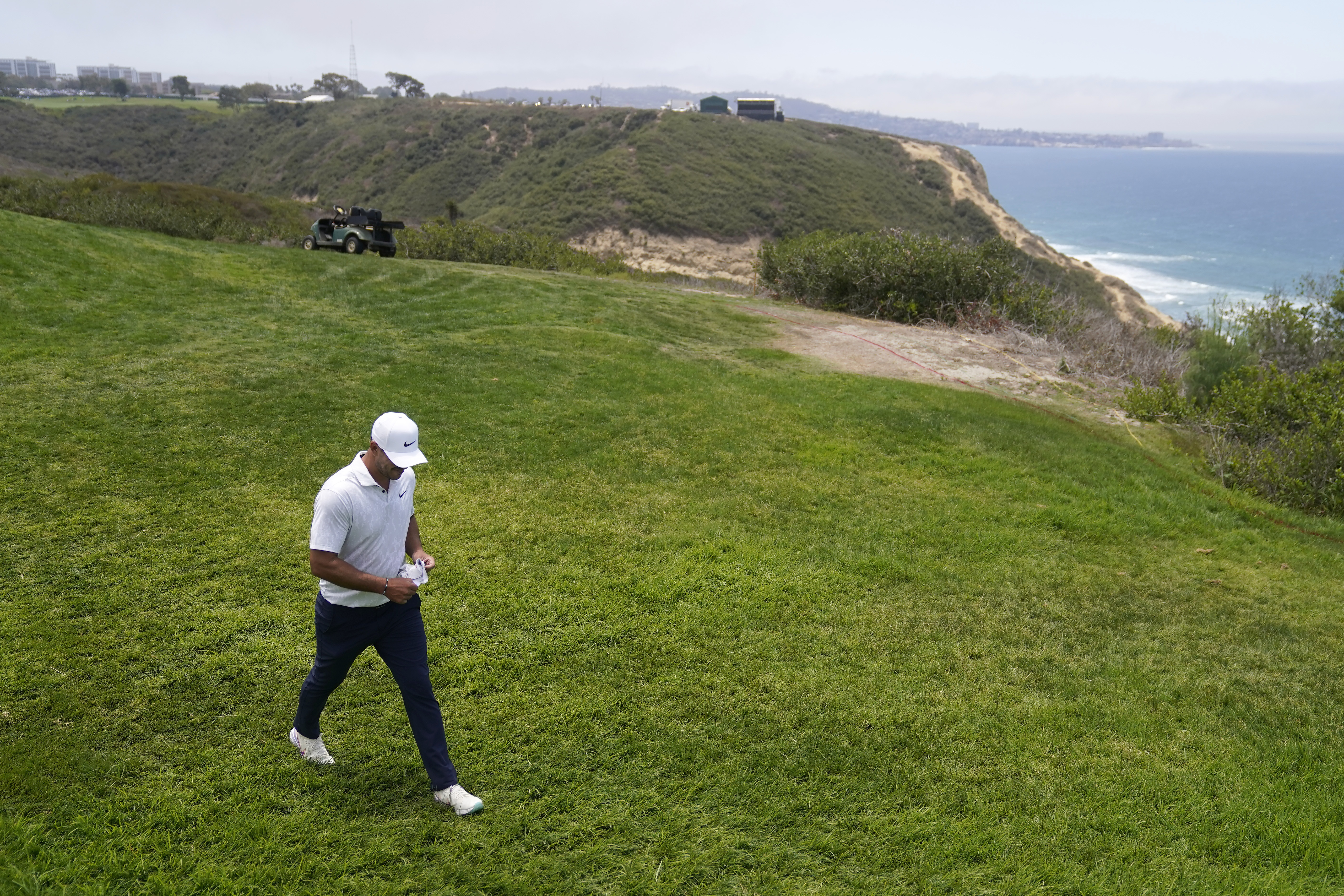 Brooks Koepka walks to the fourth tee during the first round of the U.S. Open Thursday.