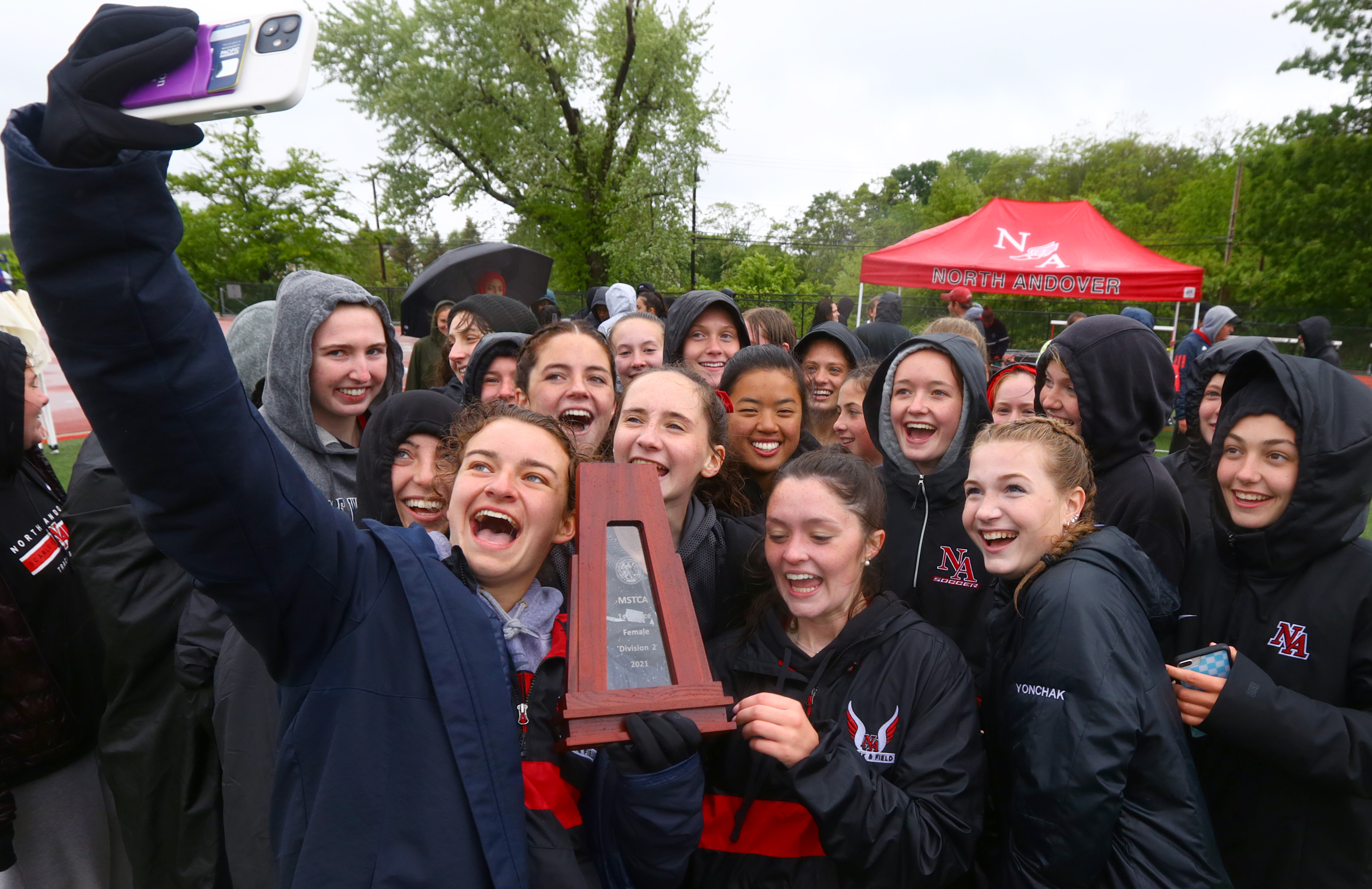 The North Andover girls' team takes a selfie with MSTCA Division 2 Relays championship trophy Sunday.