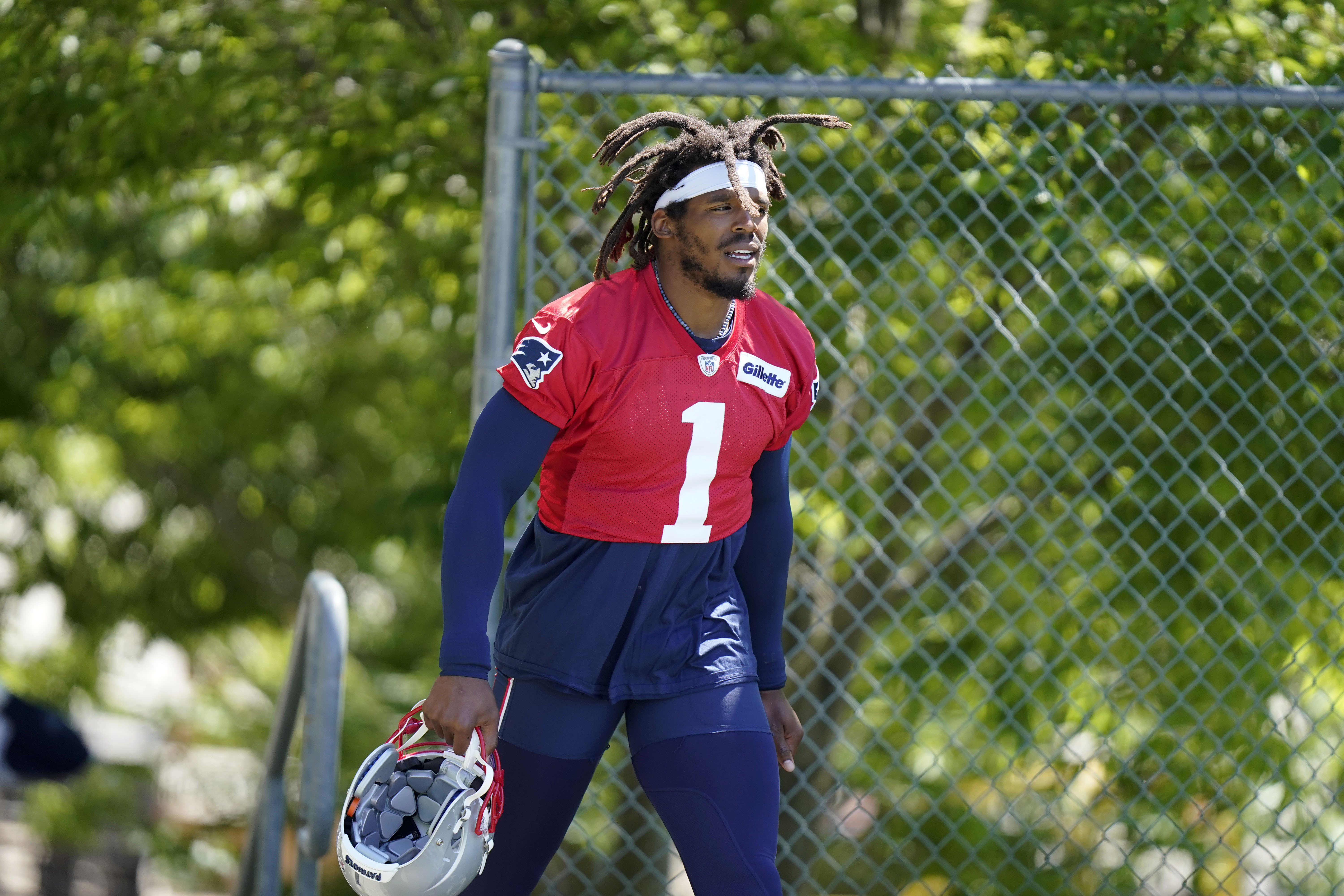 Cam Newton steps on the field at the start of a workout in Foxborough earlier this month.