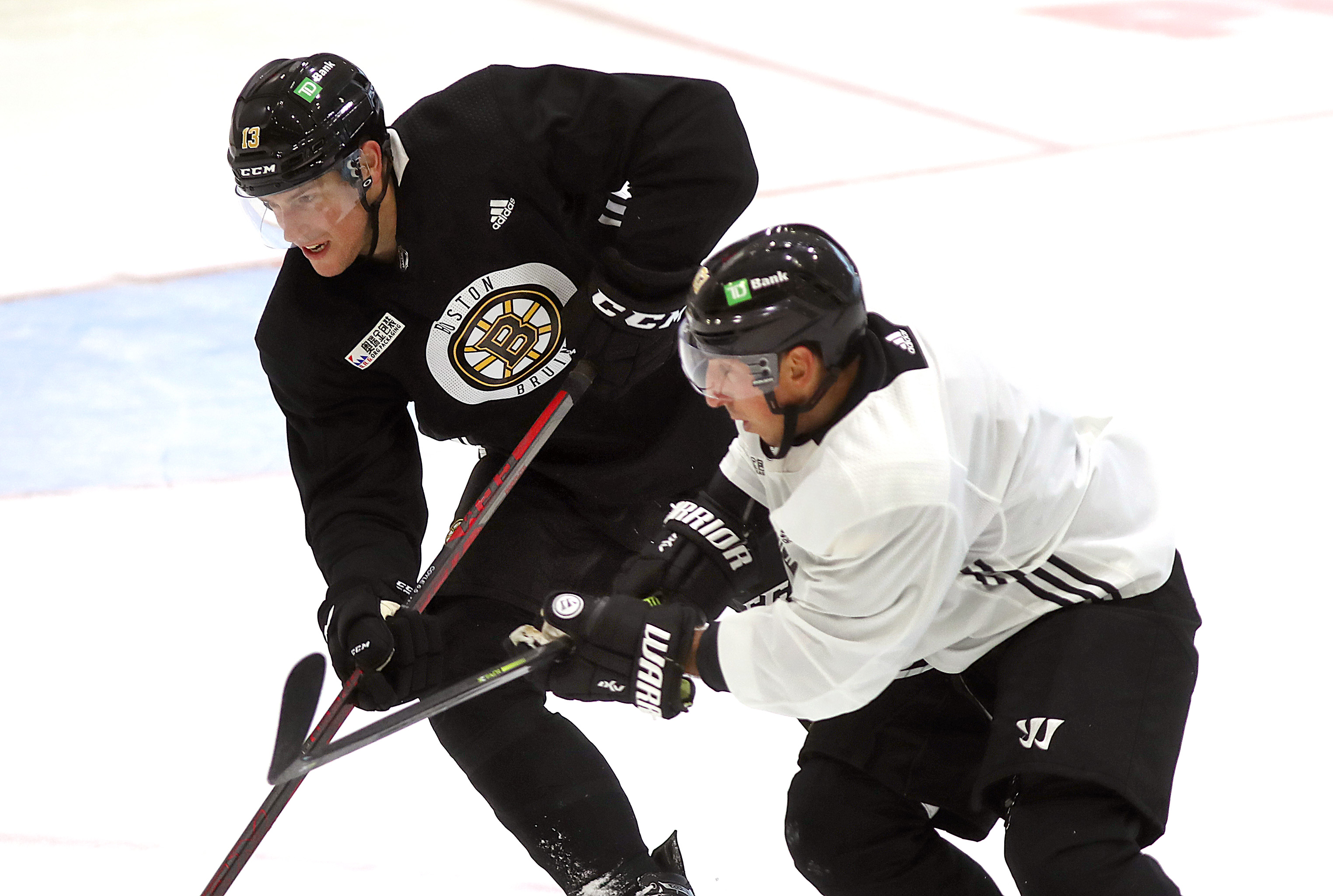Brad Marchand, right, knows there are precious few spots on the Boston roster for prospects right now.