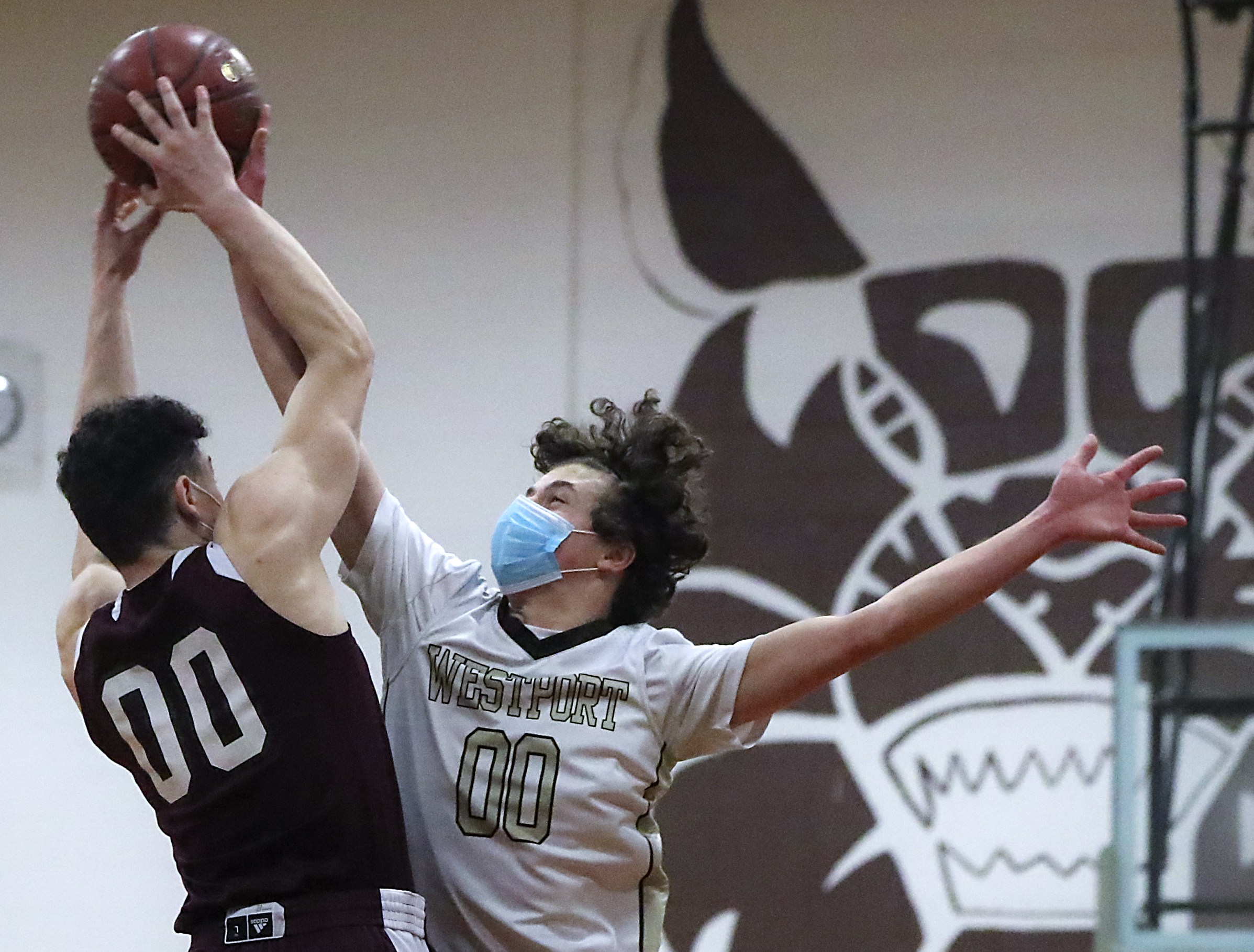 Westport's Max Powers forces a turnover as he blocks a shot by West Bridgewater's Ben Skinner’s (00) during the first quarter of Tuesday's Mayflower Athletic Conference final in Westport.