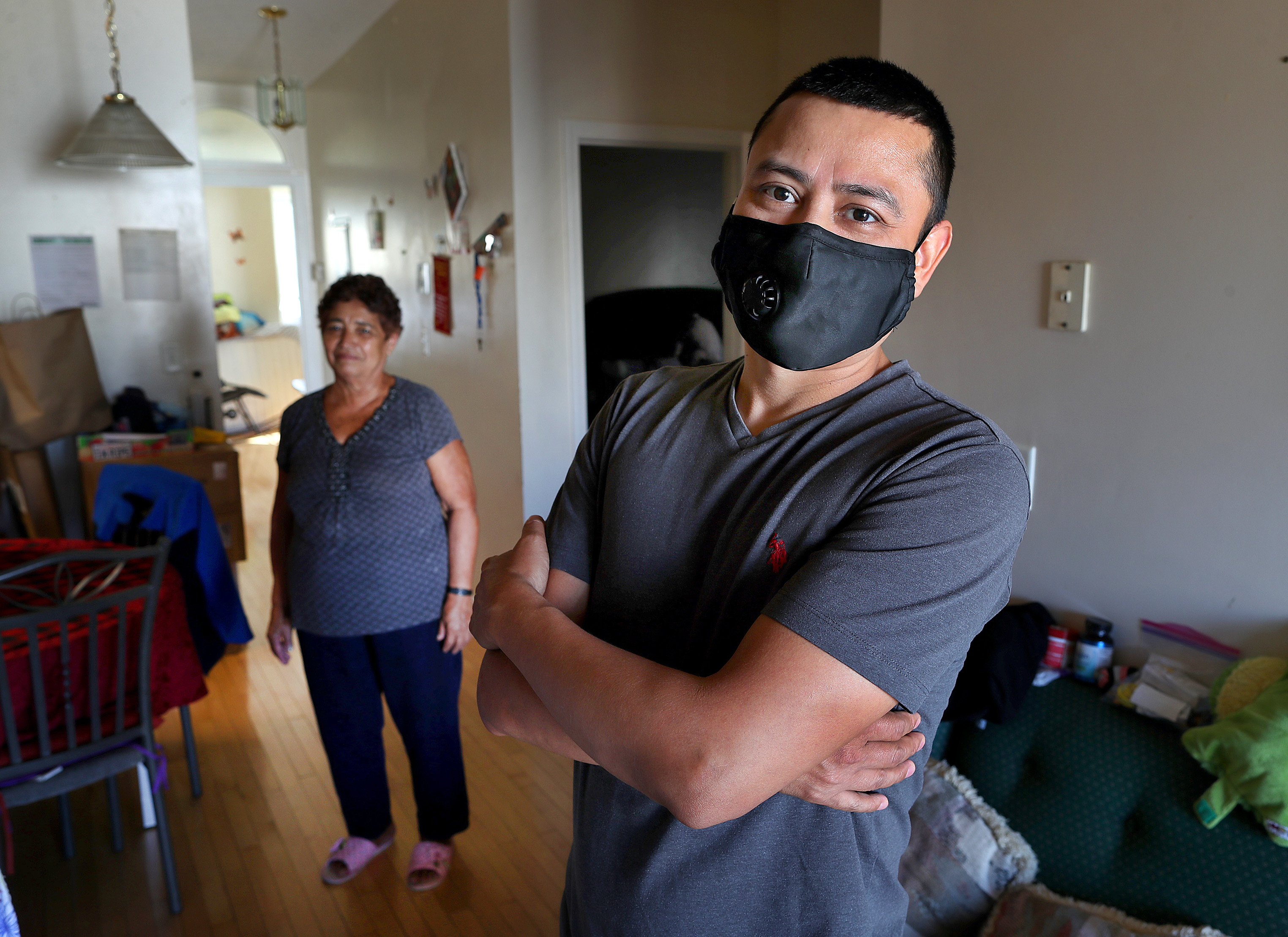 Juan Reyes, a sous chef in Brookline, with his mother-in-law, Lucia Aleman, in his East Boston home.
