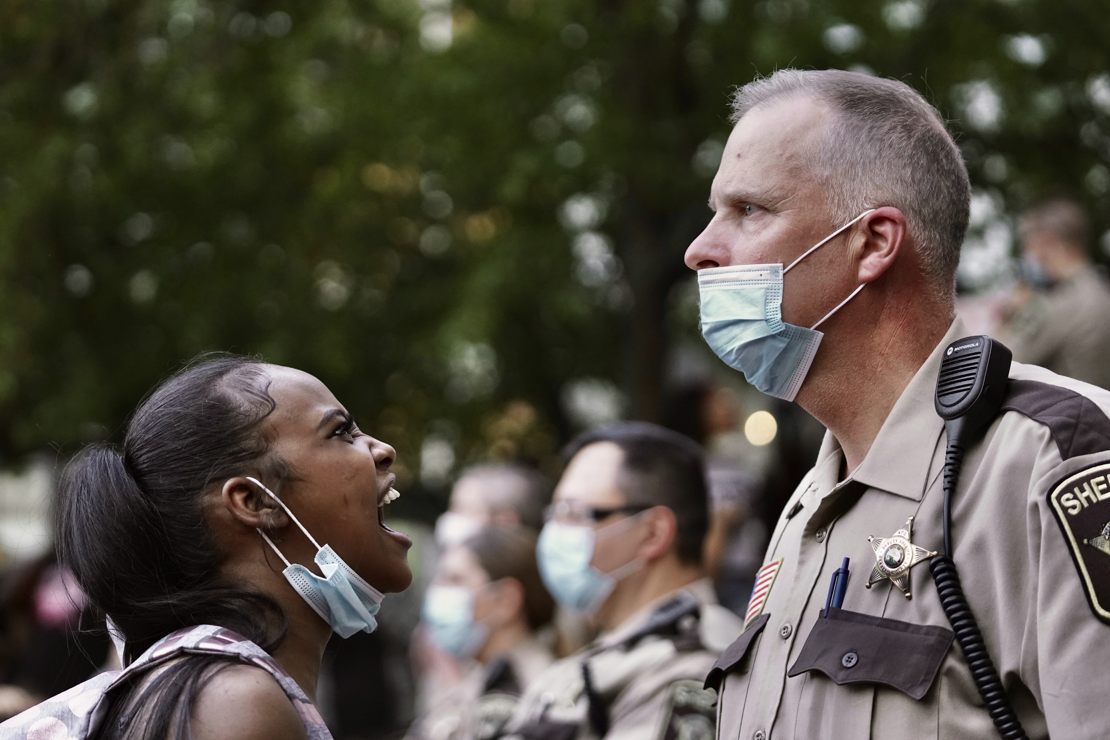 A woman yelled at a sheriff's deputy during a protest following the death of George Floyd Thursday.