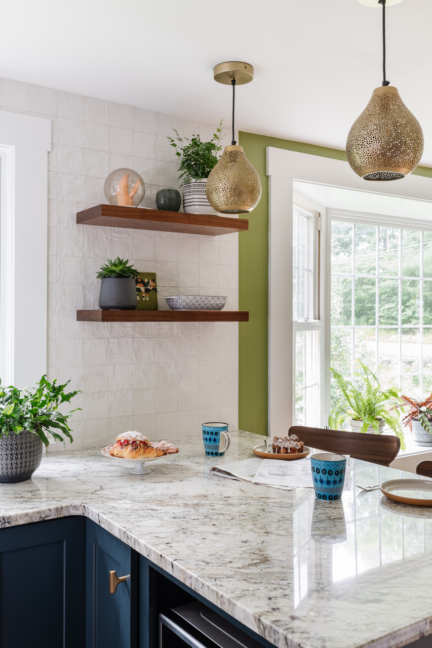 Rejecting white and gray quartz as lacking in personality, Gray and the couple chose African Rainbow granite for the countertops. “They gravitated toward pieces with movement,” Gray says. The perforated metal pendants are by Surya.
