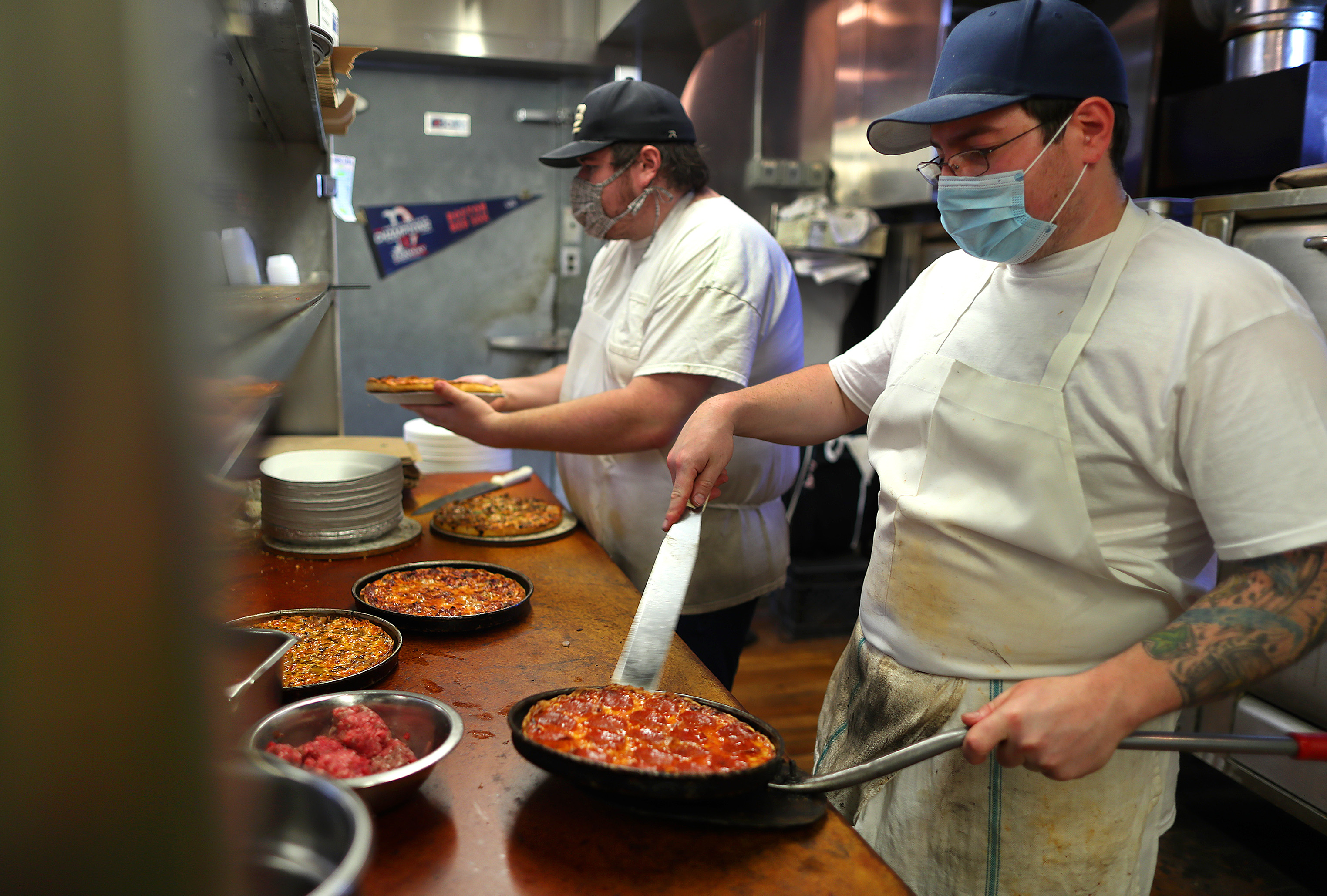 Cook Michael Gold takes a pizza out of the oven at the Lynwood Cafe.