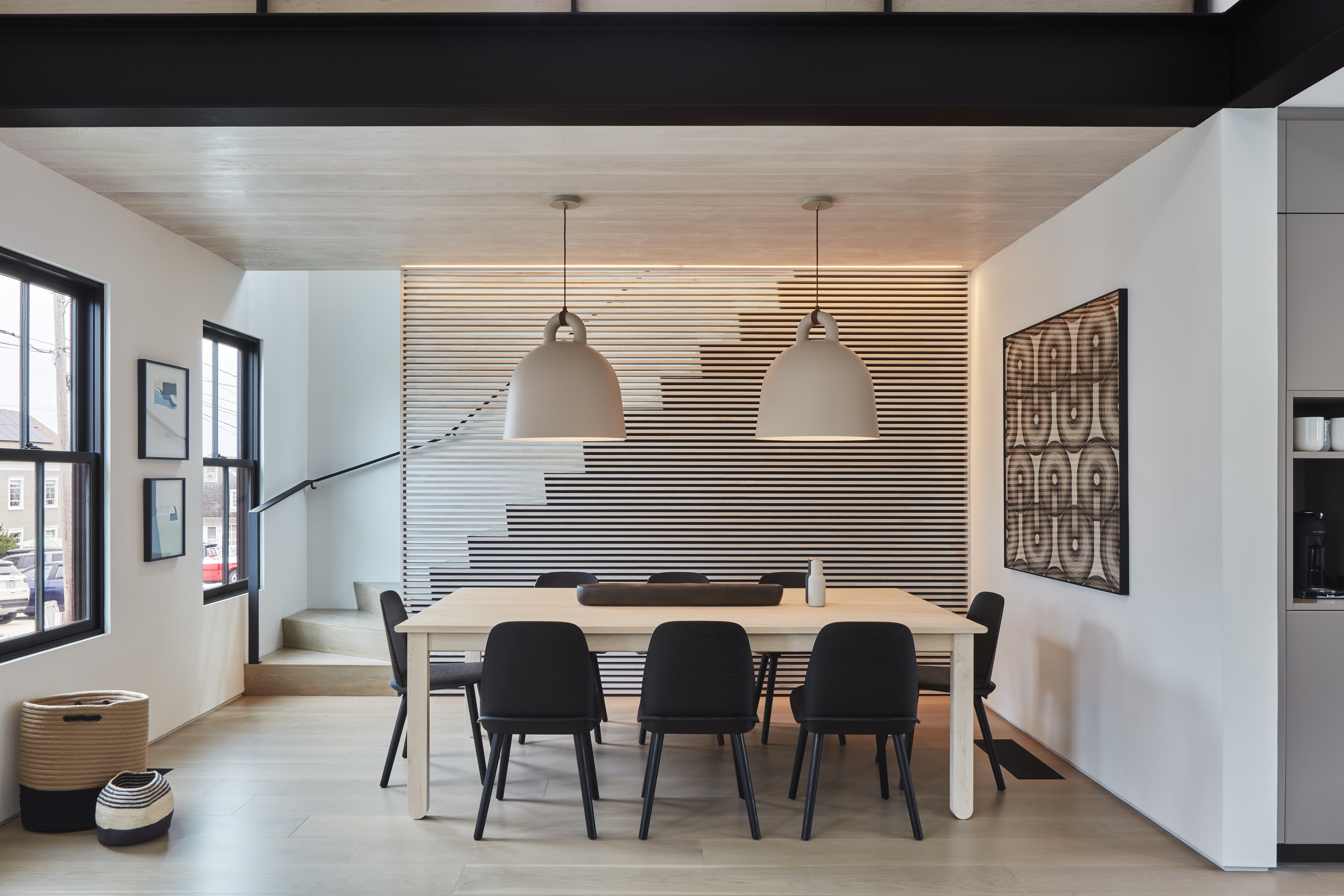 Normann Copenhagen pendants make a statement without distracting from the silhouette of the stairs. Artist Katrine Hildebrandt created the large abstract artwork at right. The two small pieces at left are by Charlotte Lethbridge.