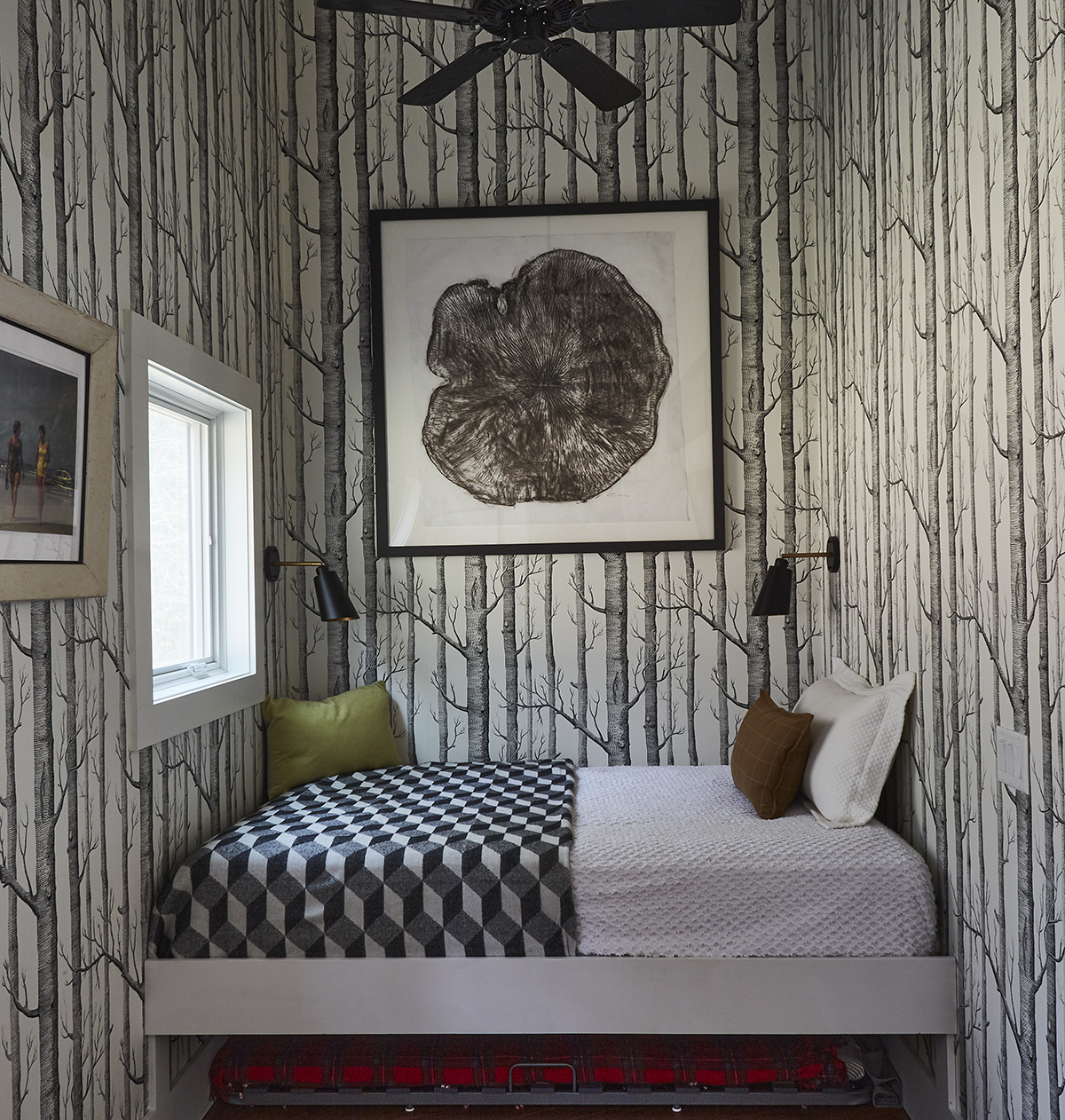 Cole & Son Woods wallpaper lines the nook, which Katherine Slingluff says is “wonderfully cozy” when the barn doors are closed. She did the charcoal rubbing of a tree trunk left in Prospect Park after
Hurricane Sandy.