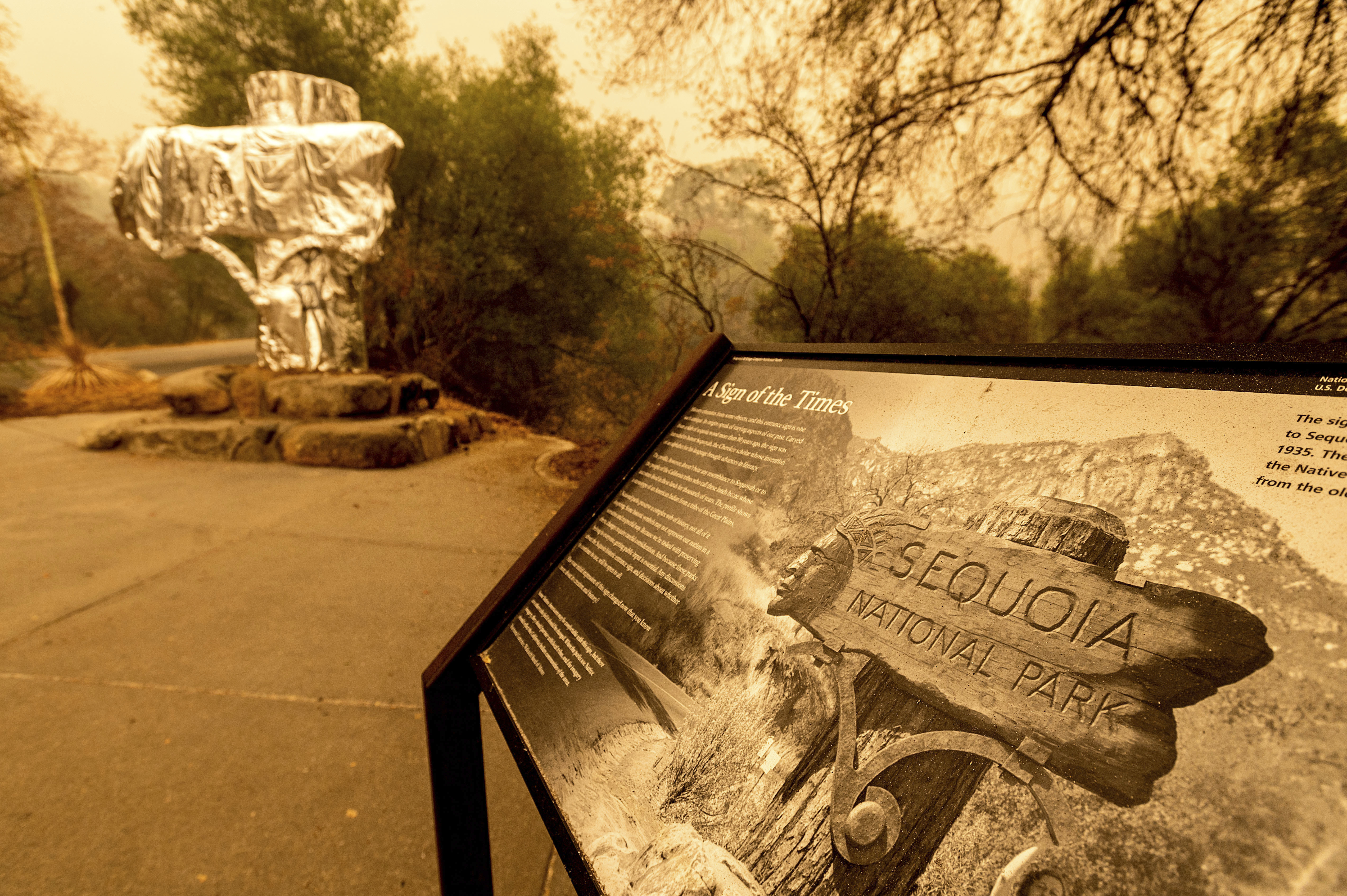 Fire-resistant wrap covered a historic welcome sign as the KNP Complex Fire burns in Sequoia National Park, Calif., on Wednesday.