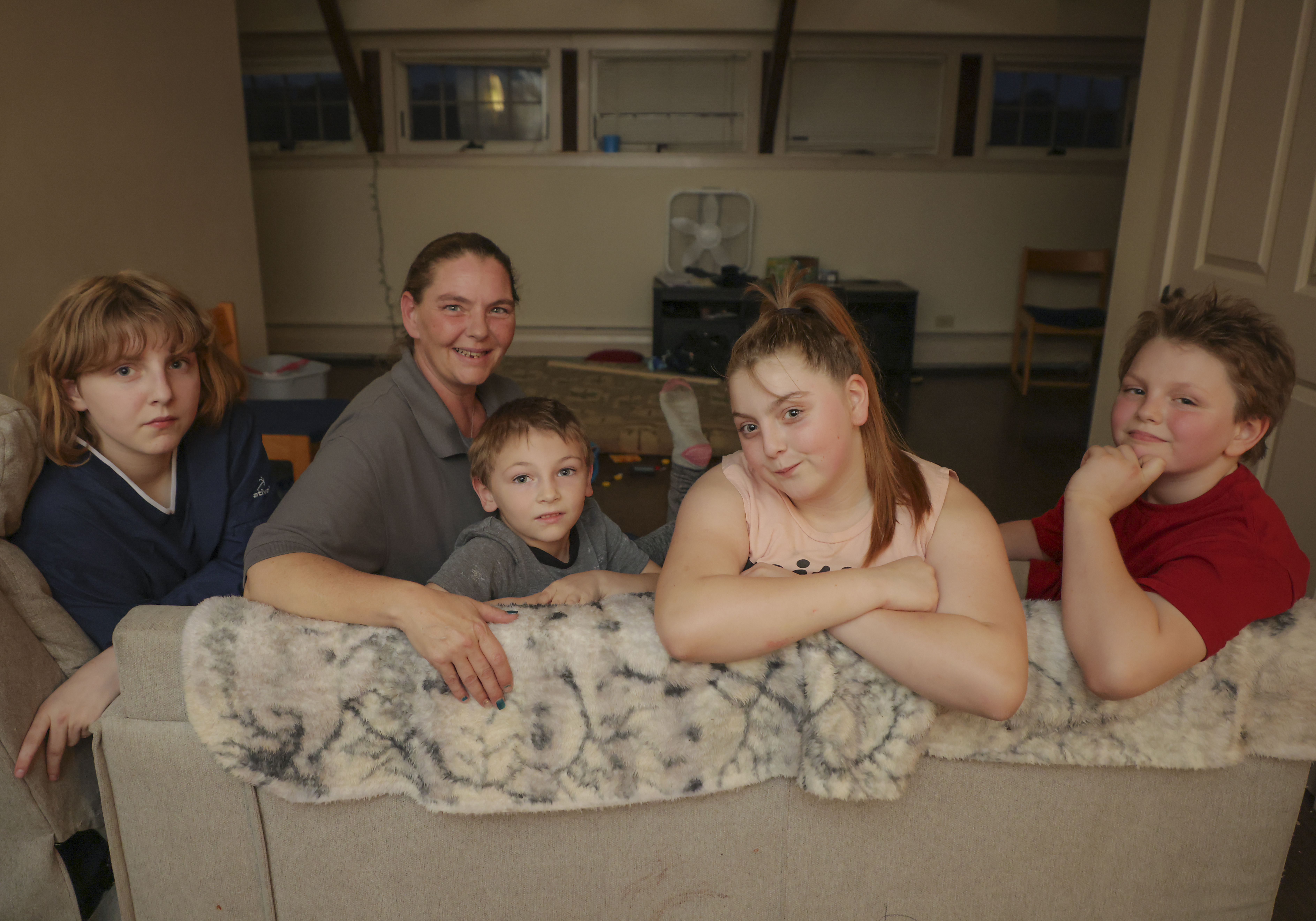 Crystal Lambert, second from left, with her children Calypso, Elias, Mysteria, and Bryan, in their living room.