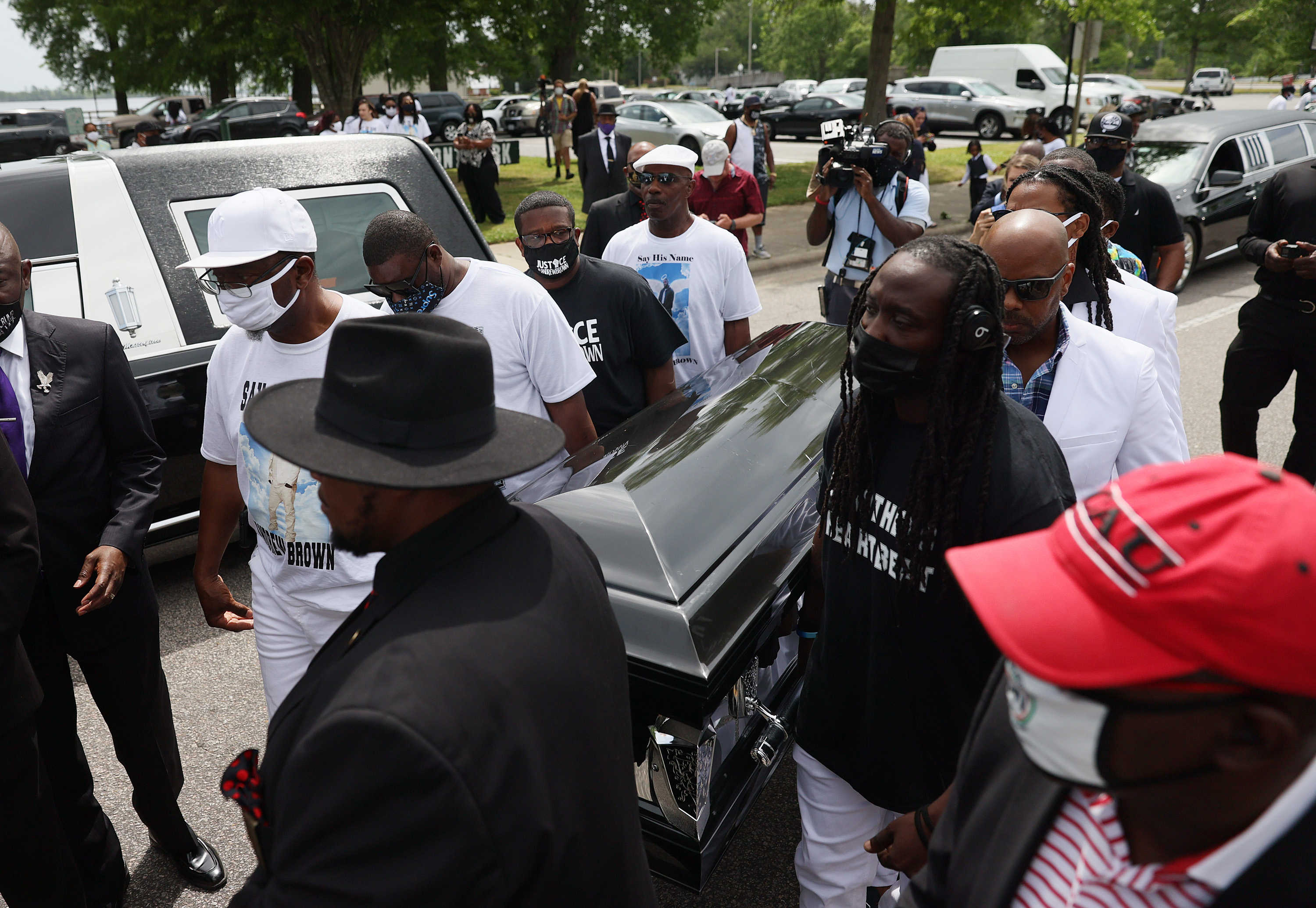 Pallbearers carried the casket of Andrew Brown Jr. to a horse drawn carriage before his funeral service.