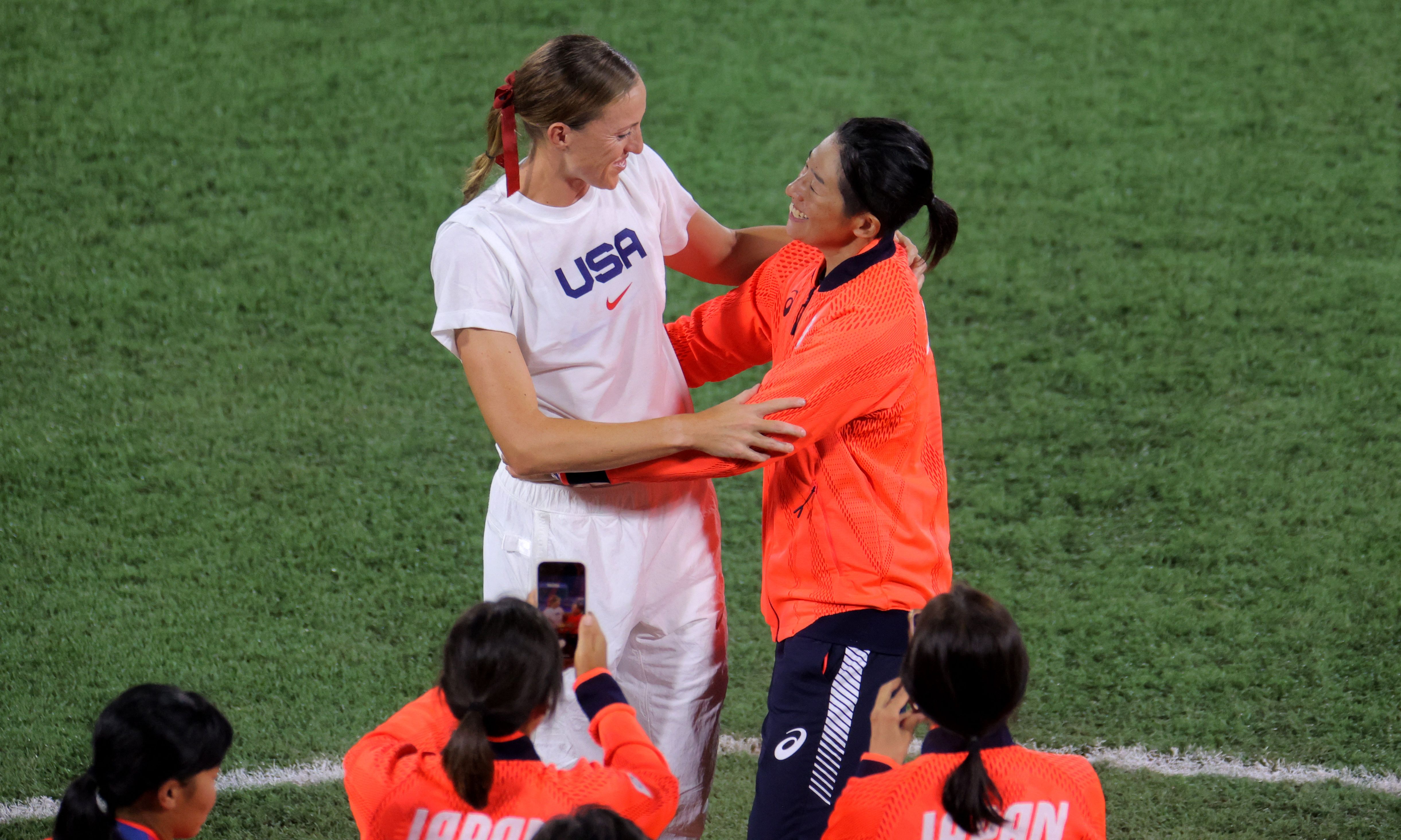 Japan's Yukiko Ueno hugs USA's Monica Abbott after the gold-medal game.