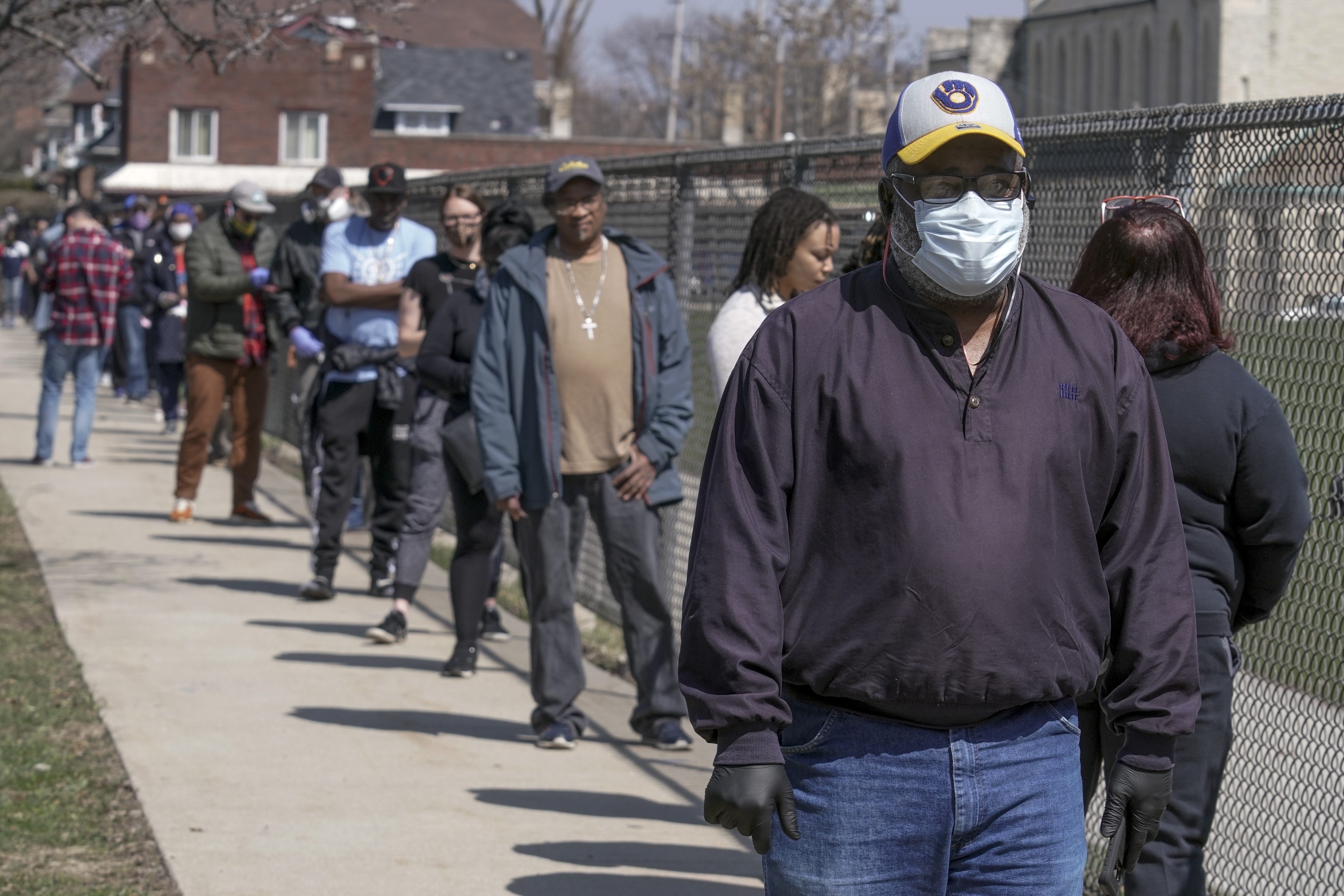 In this April 7 photo, voters observe social distancing guidelines as they wait in line to cast ballots in the presidential primary election in Milwaukee.