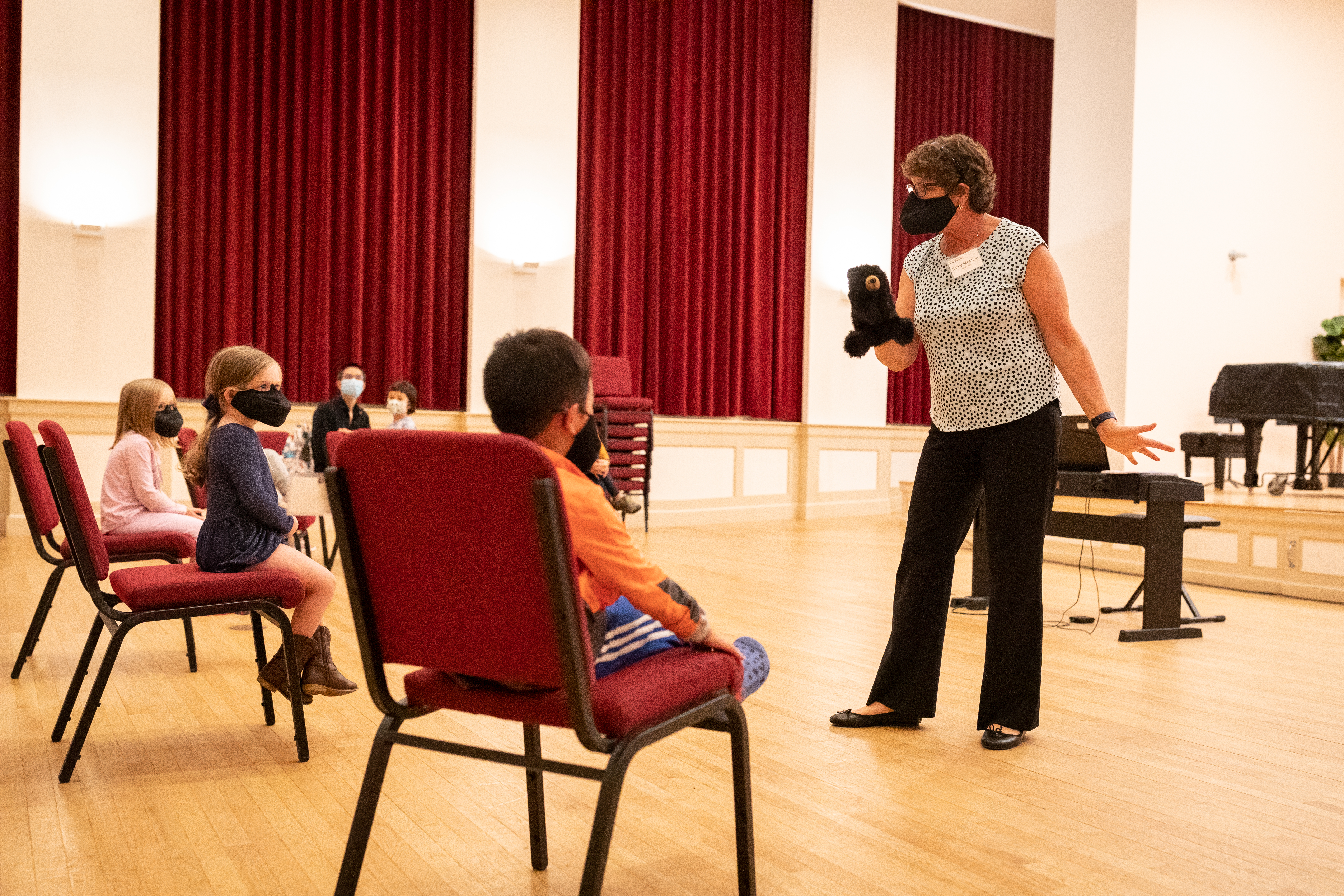 Kathy McMinn, Youth Chorus Director at Indian Hill, uses a puppet as part of a warm up activity during a chorus class for 4- and 5-year-olds.