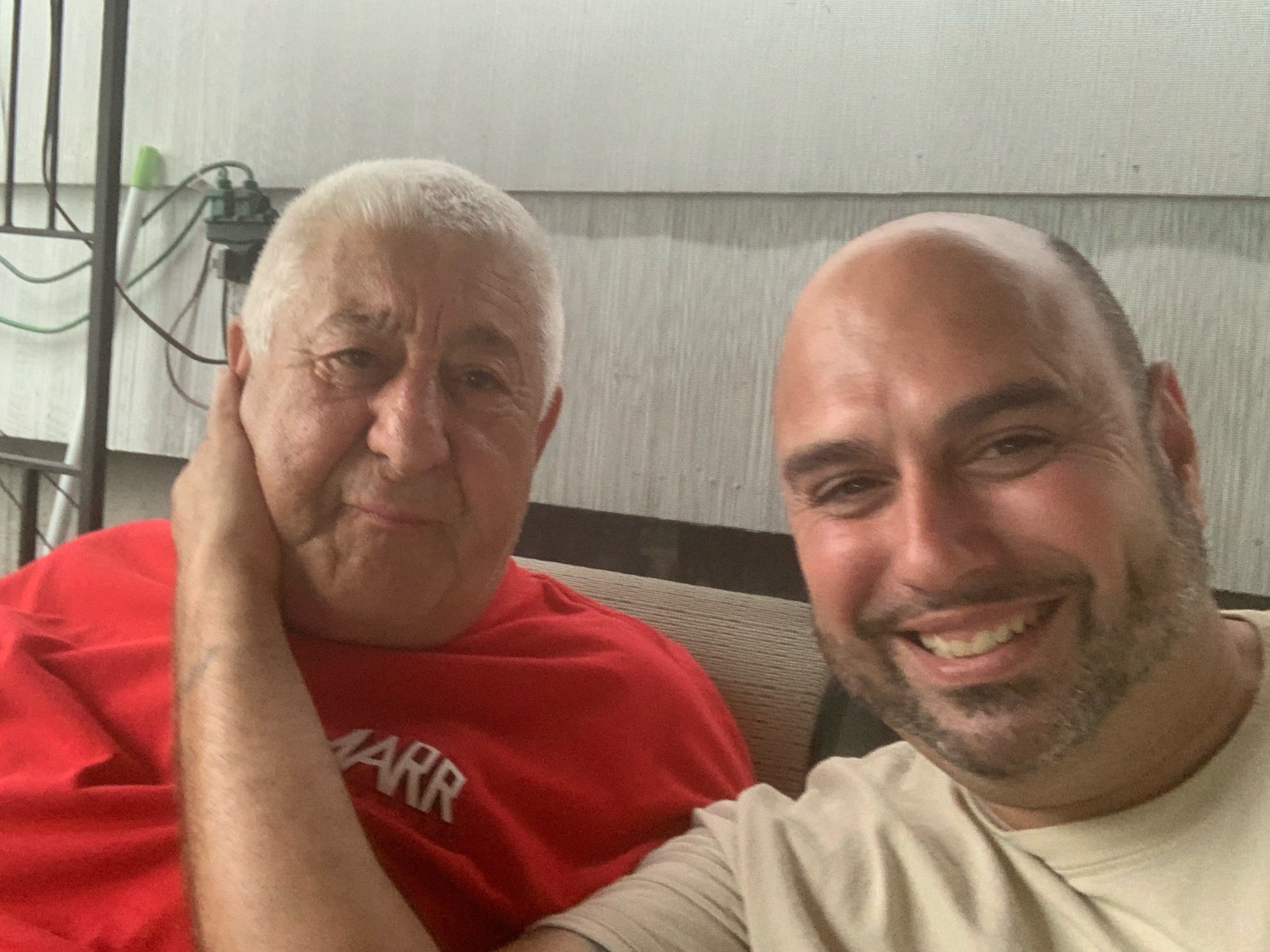 Vincenzo Bitto, left, and his son-in-law Kanye Medeiros, at a backyard party in Brockton, Mass.