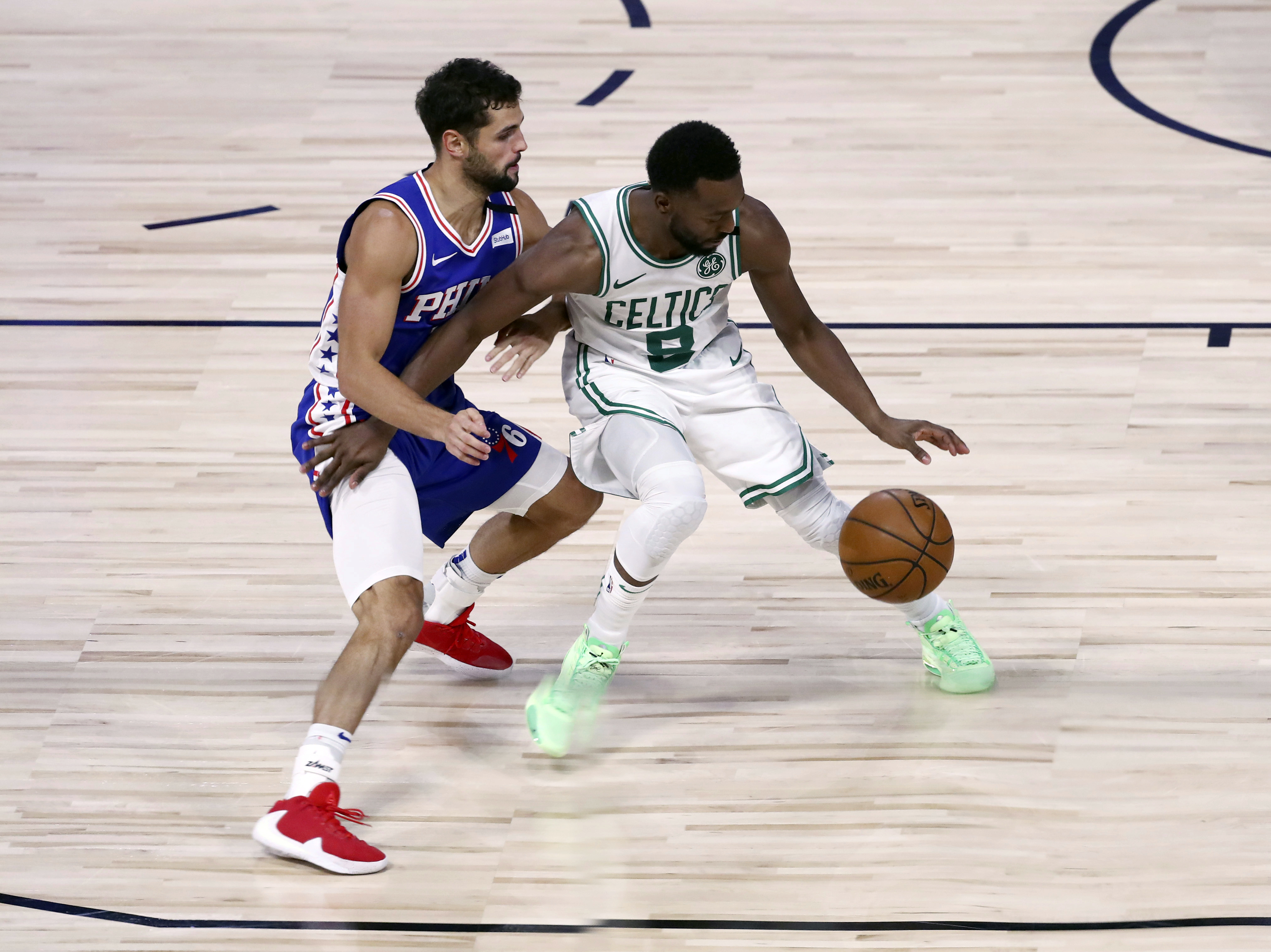 Kemba Walker dribbles as Philadelphia's Raul Neto defends during the second half of Sunday's game.