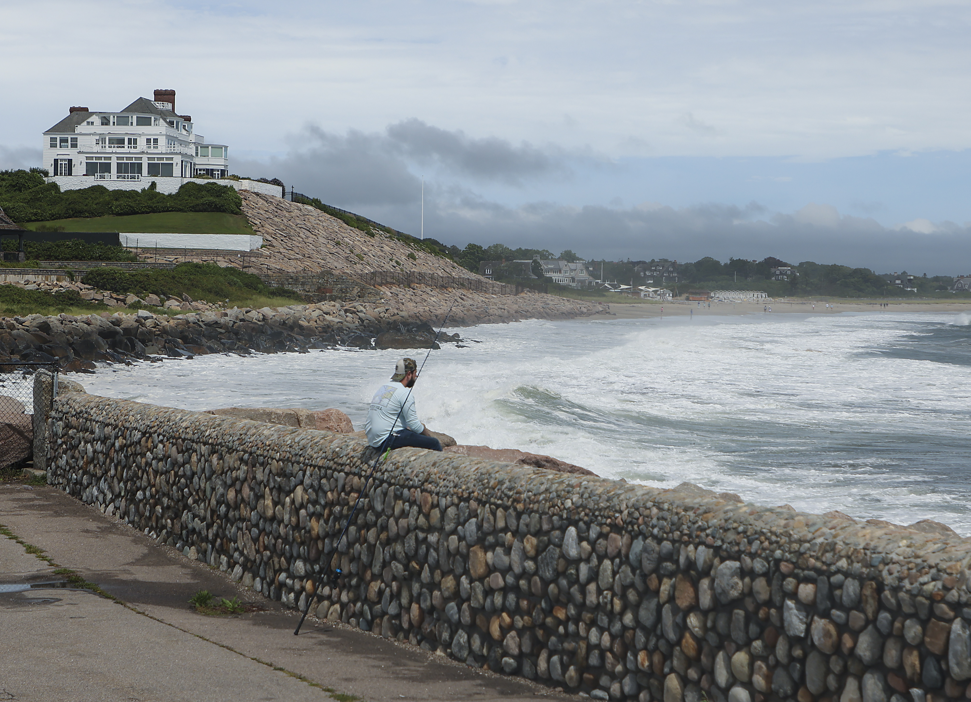 Dan Falcone fished at the Watch Hill Lighthouse for striped bass with home of Taylor Swift in the background as the eye of Tropical Storm Henri passed through.