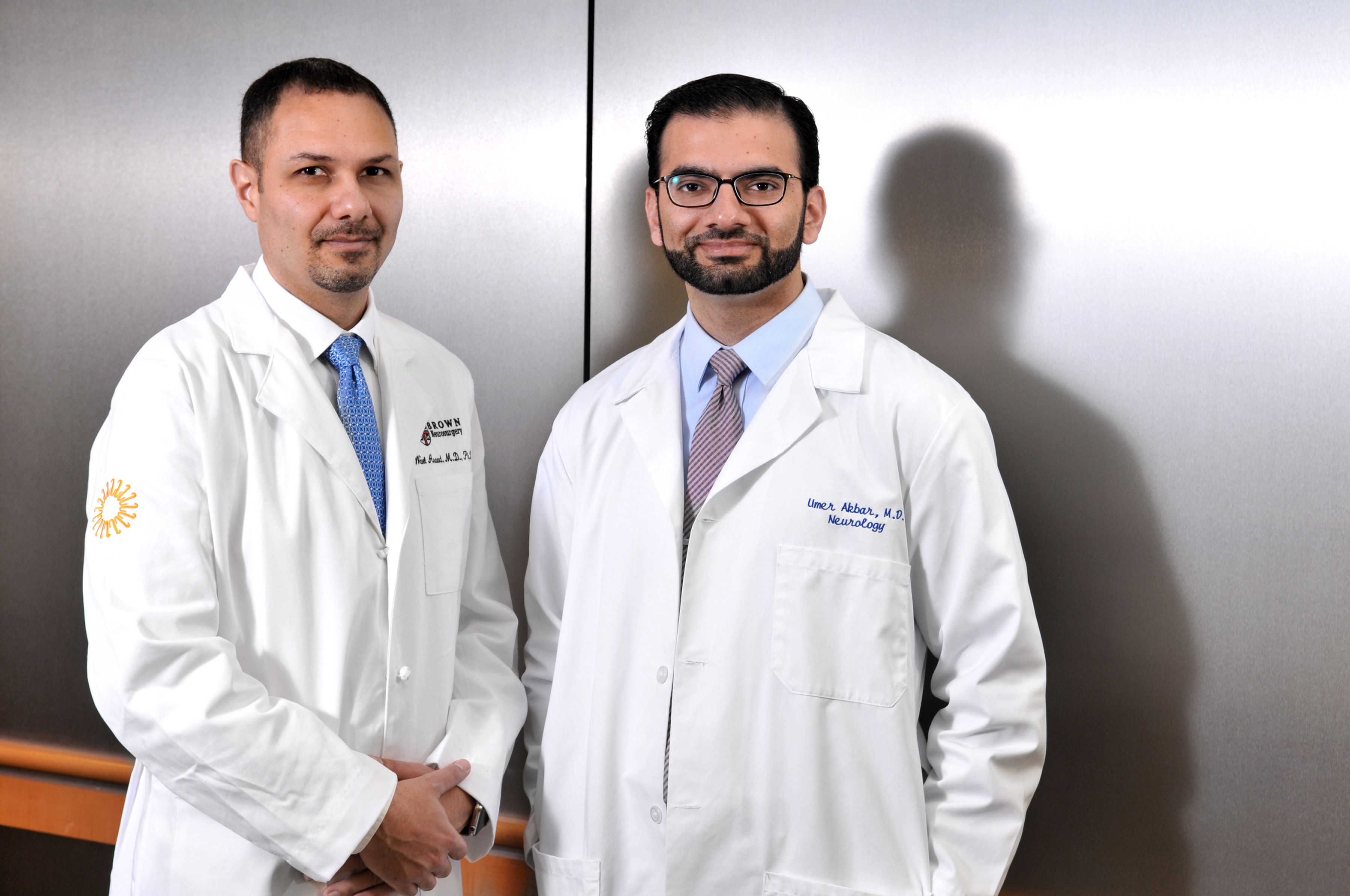 Dr. Wael Asaad (left) is the director of the Norman Prince Neurosciences Institute’s Functional Neurosurgery & Epilepsy program, and Dr. Umer Akbar is a neurologist and co-director of the Movement Disorders and Deep Brain Stimulation programs at Rhode Island Hospital.